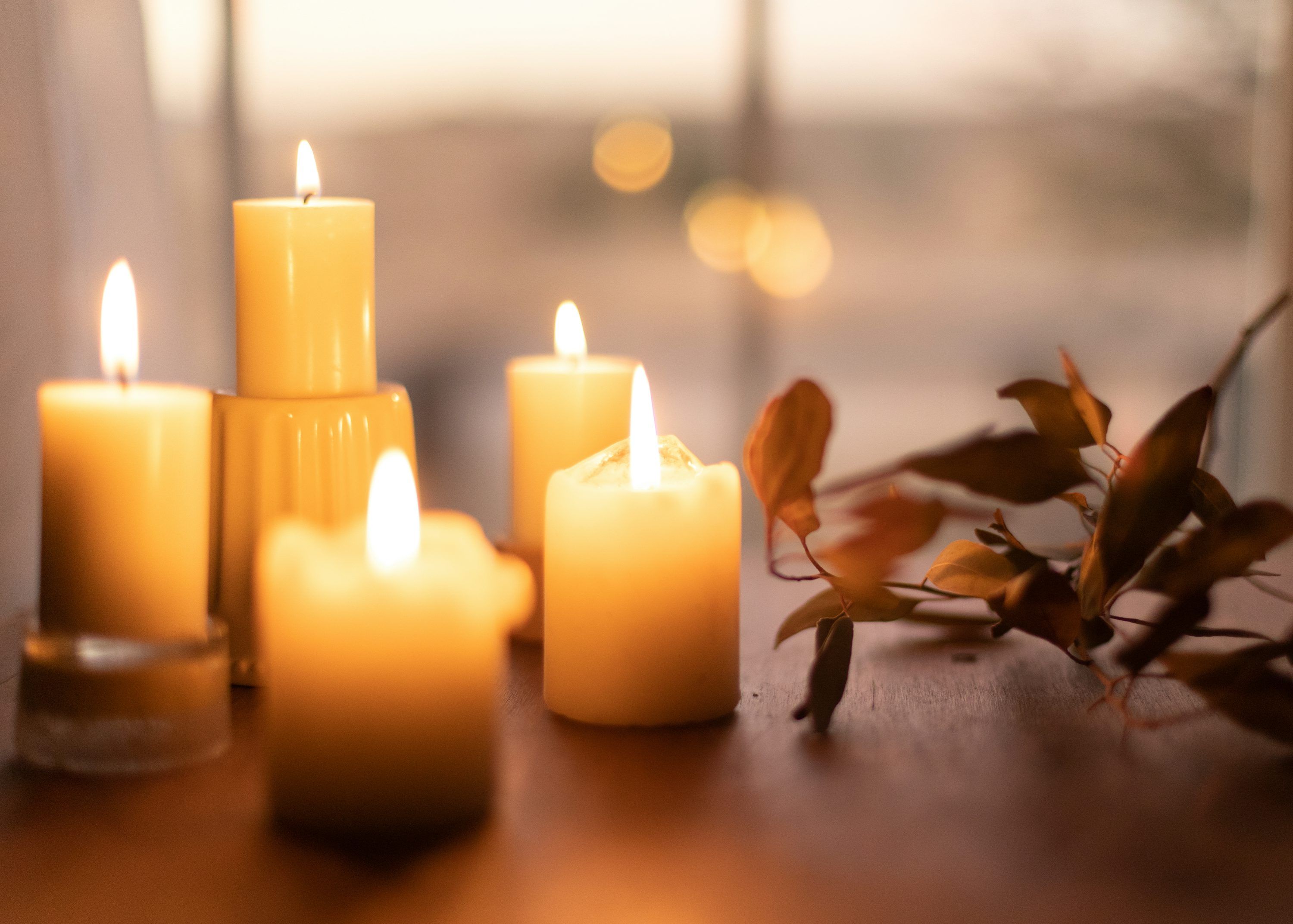 3000x2143 White pillar candles on brown wooden