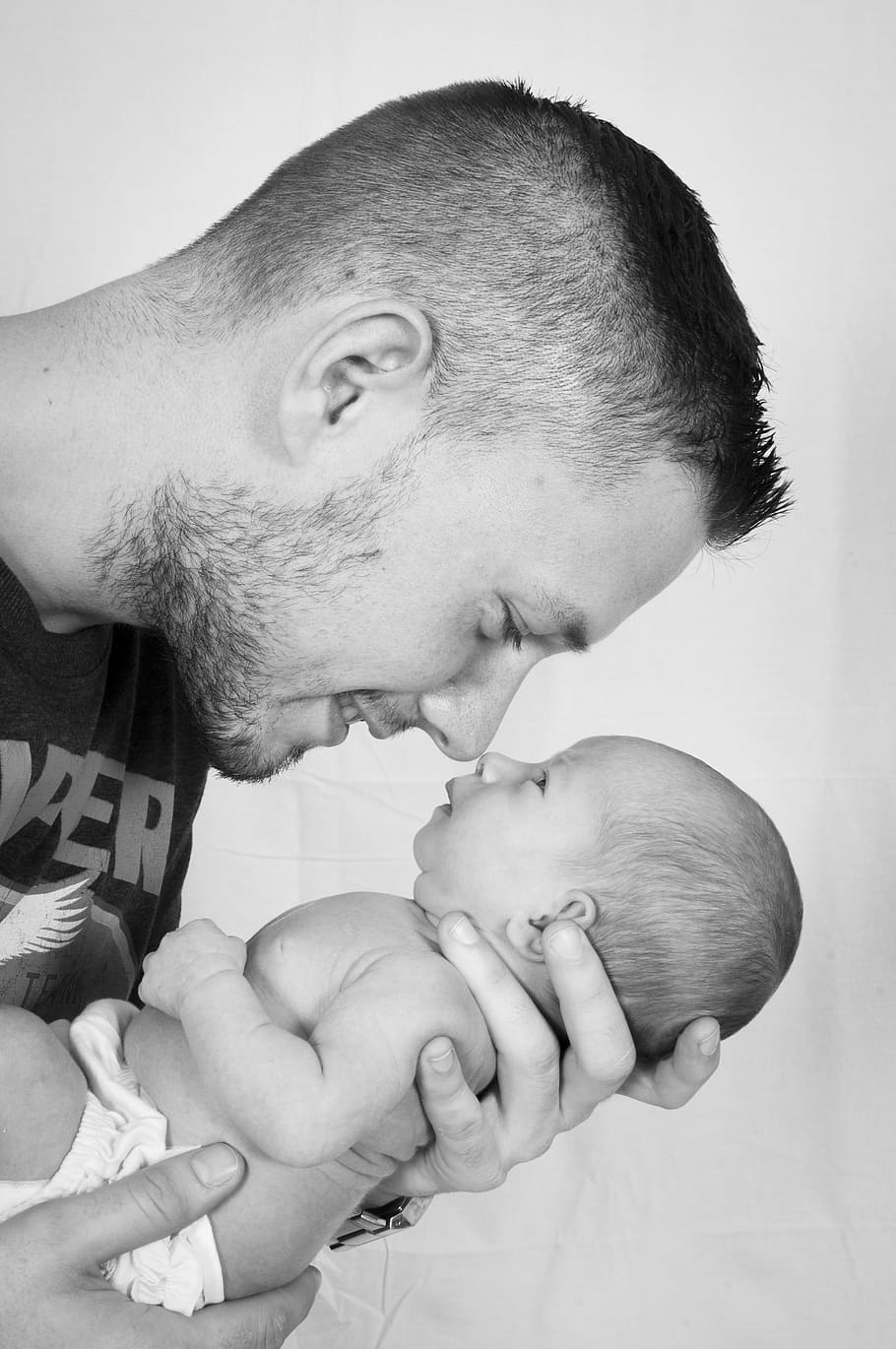 910x1370 HD wallpaper: smiliing man holding baby