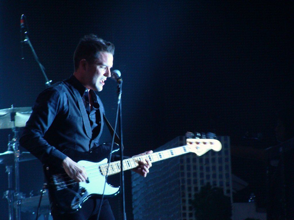 1024x768 Brandon Flowers playing the bass guitar