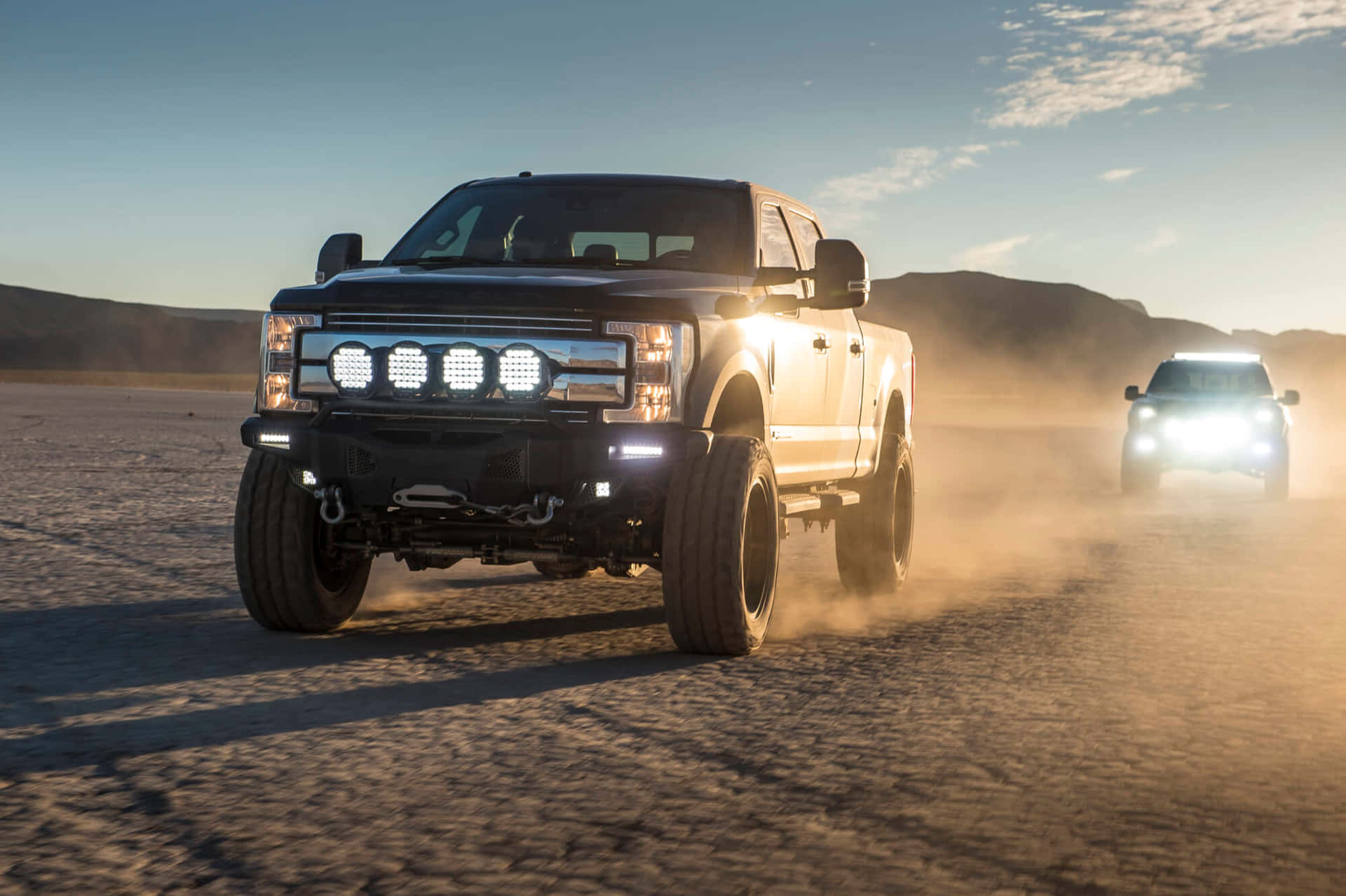1920x1278 Trucks With Lit Up Headlamps Wallpaper