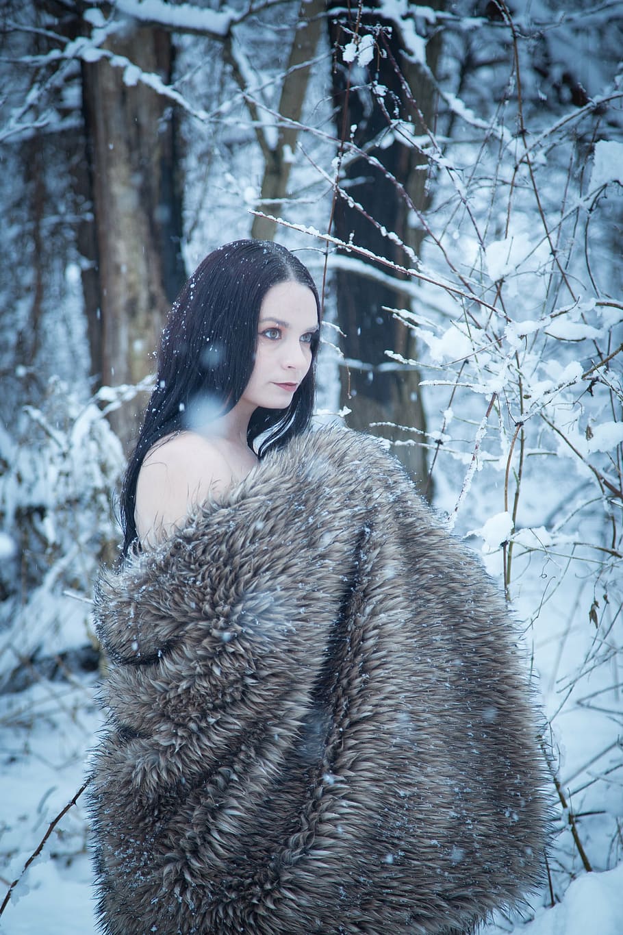 910x1365 woman wearing brown fur coat standing