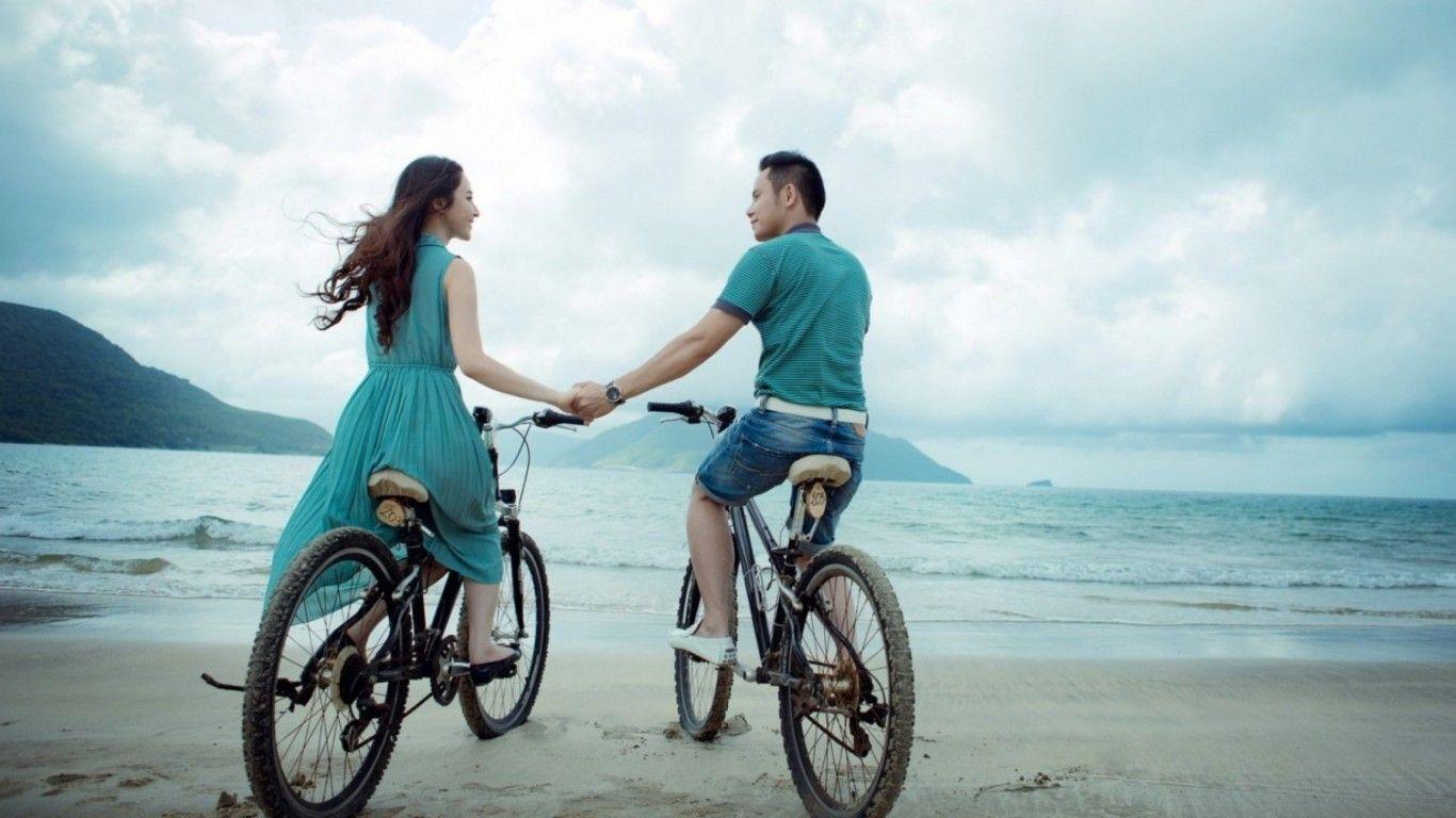 1366x768 Couple Bicycle Riding On Beach HD Wallpaper 75