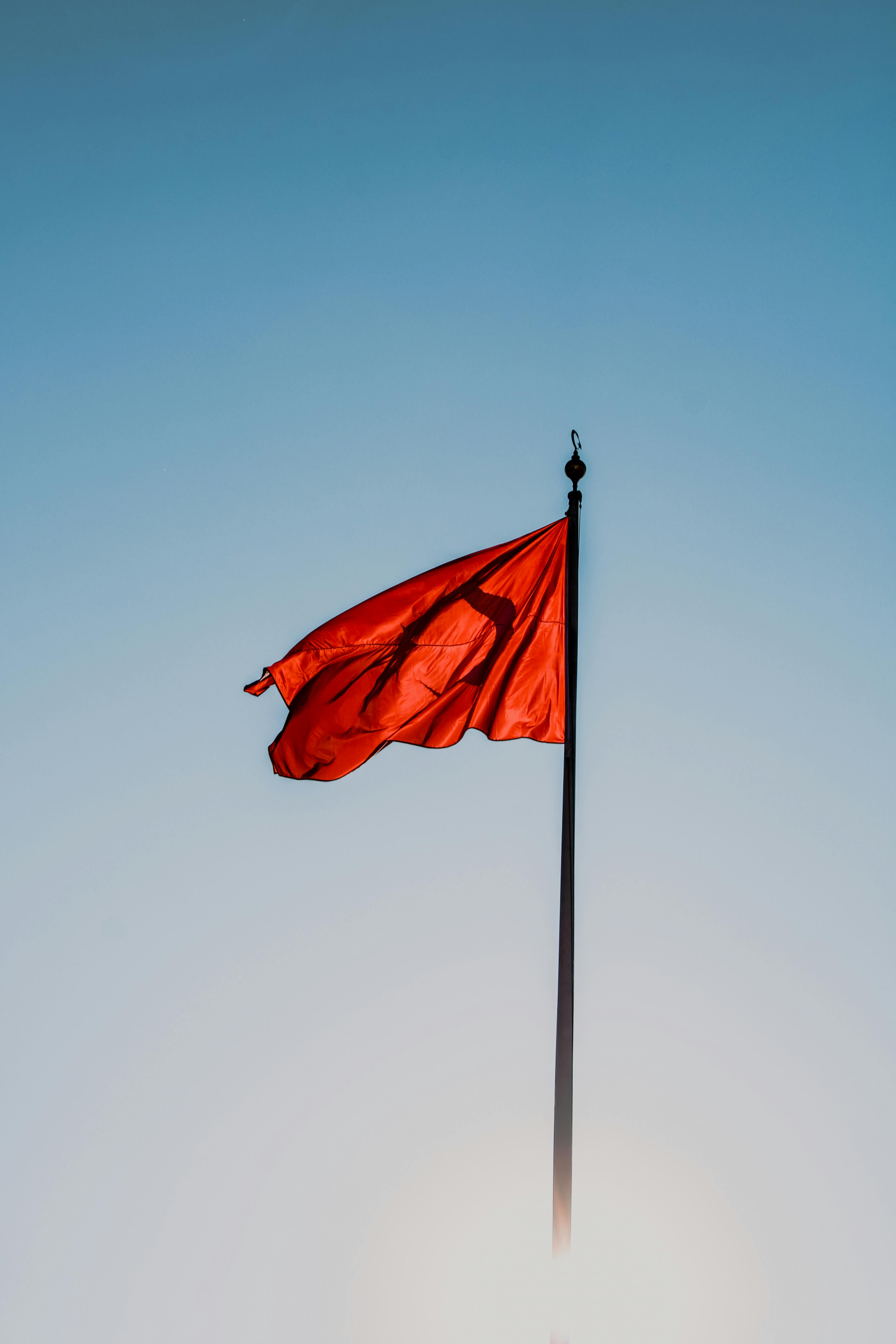 3869x5803 Red Flag on a Black Flagpole against