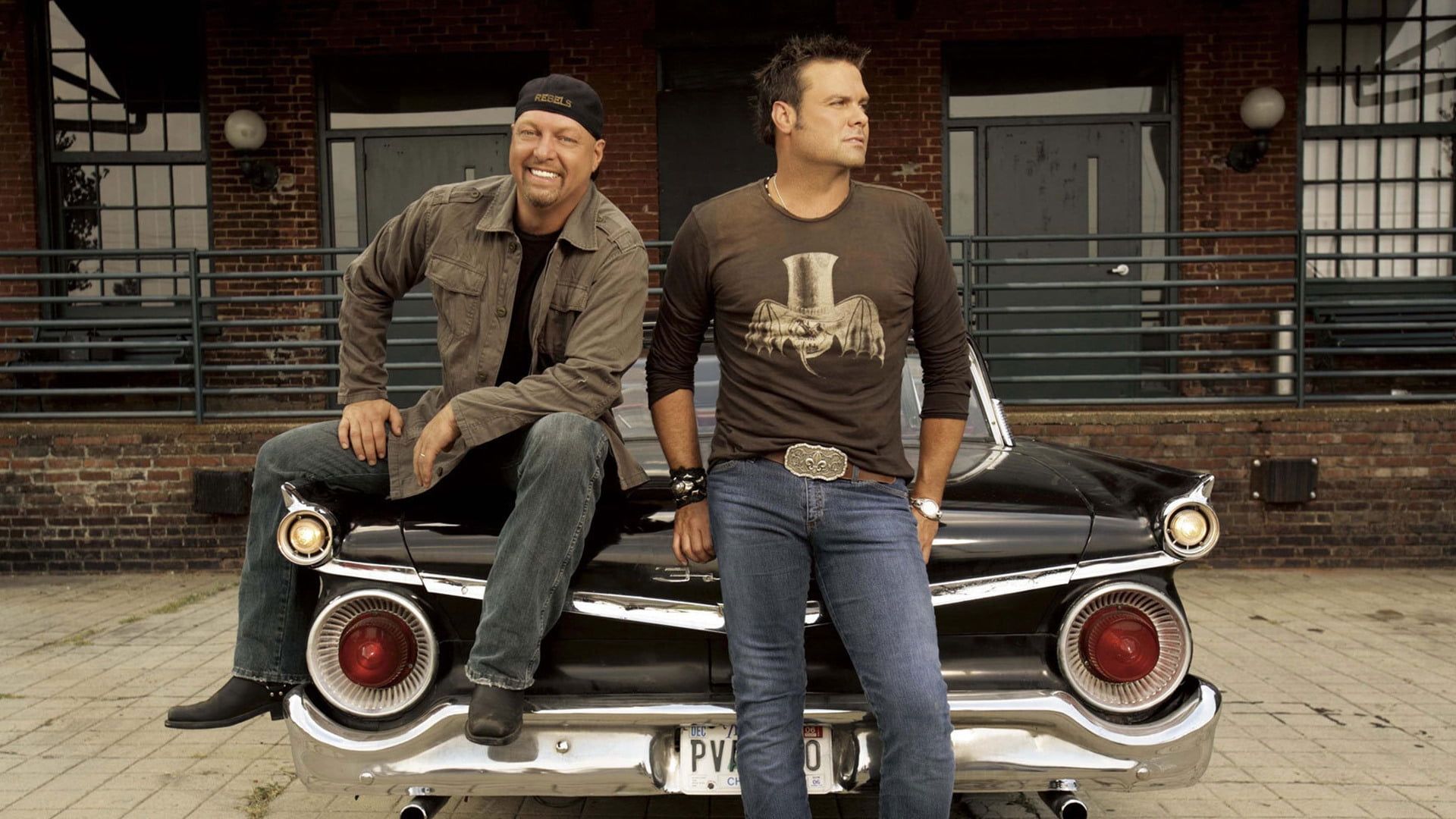1920x1080 Two men sitting of black classic car