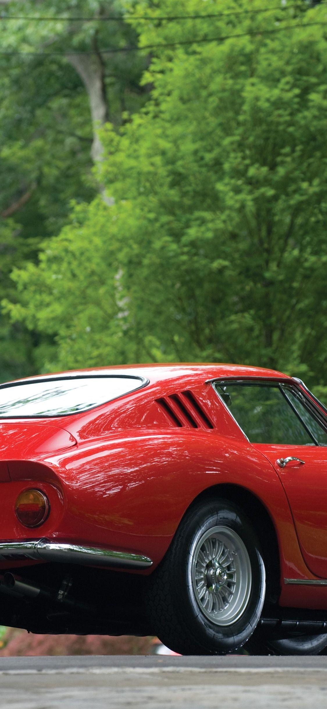 1125x2436 Ferrari red classic car rear view, green trees 1242x2688