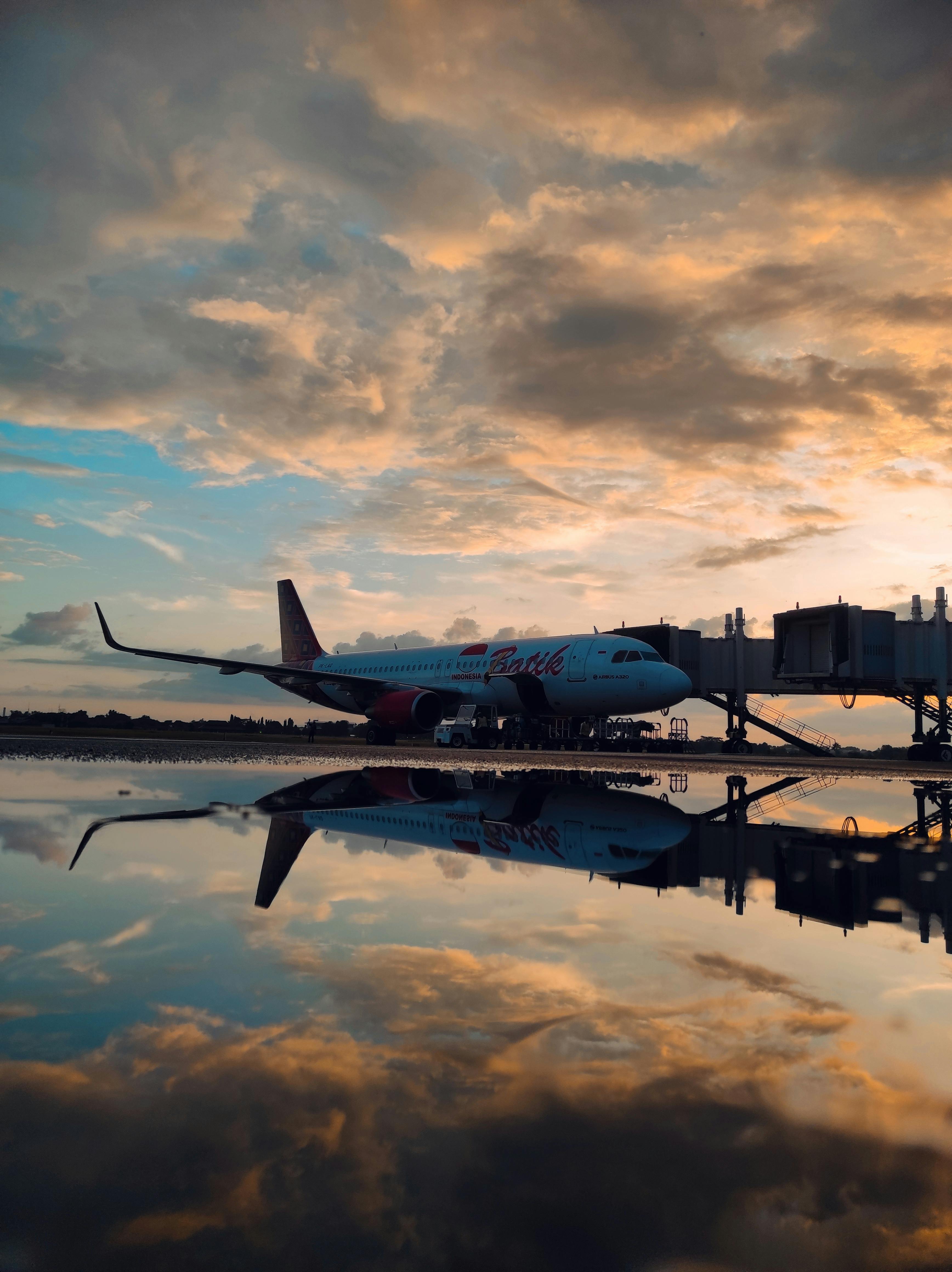 3472x4640 View of an Airplane at an Airport under a Sunset Sky · Free