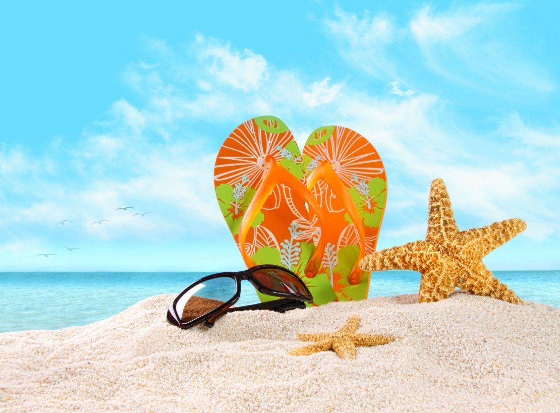 1130x833 Flip flop and sunglasses on the beautiful golden beach sand