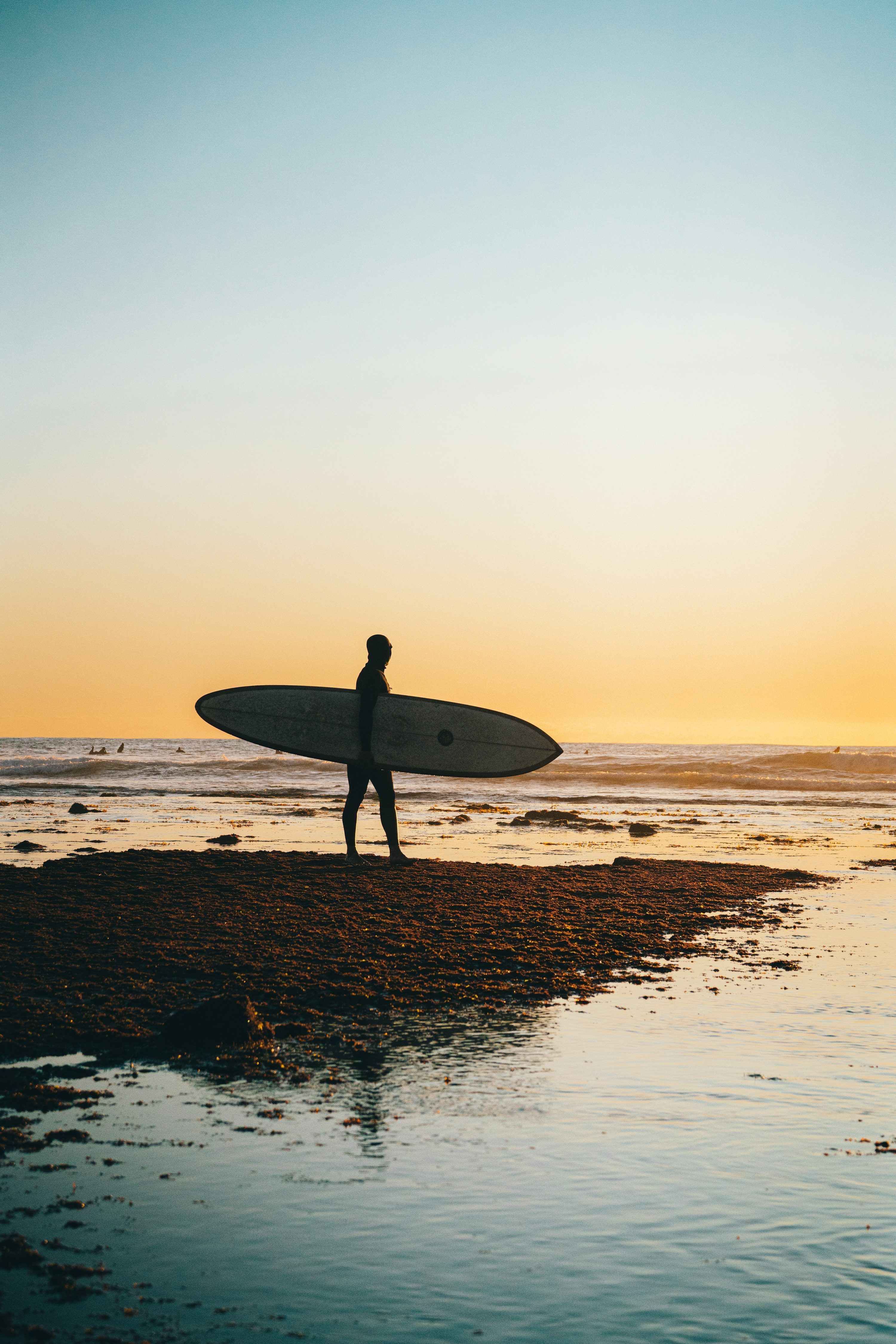 3000x4498 Man holding white surf board photo