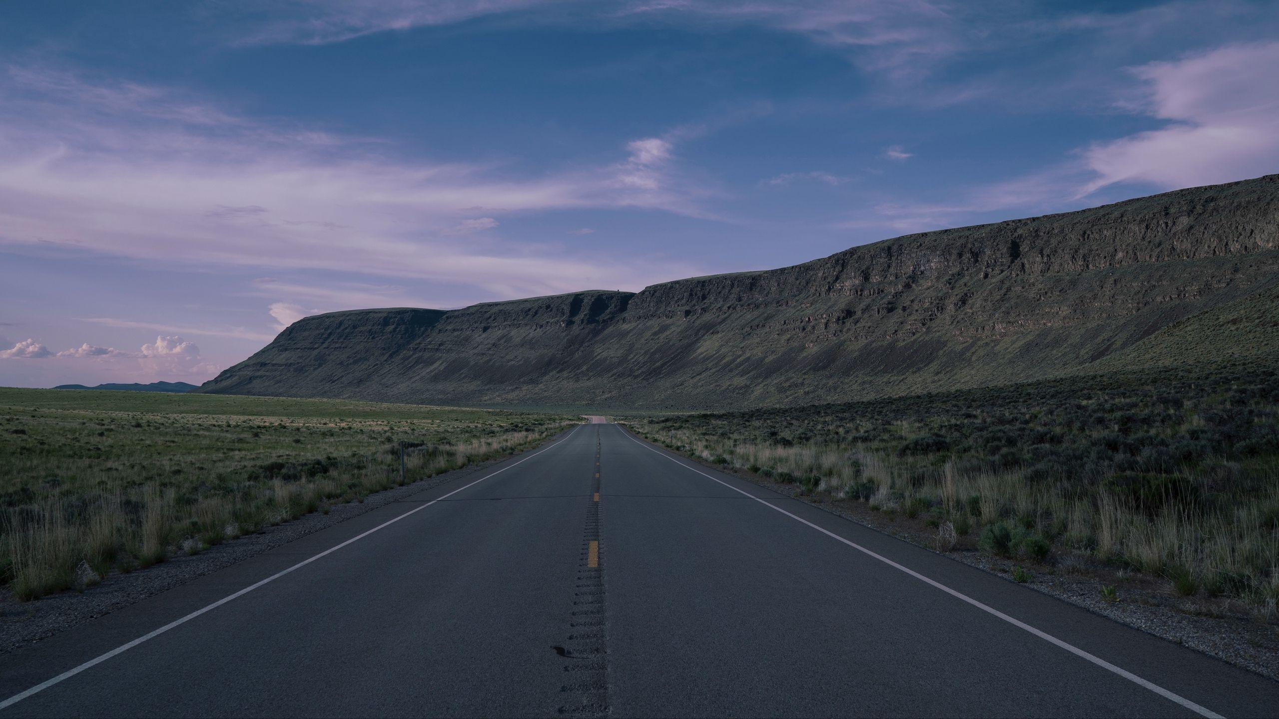 2560x1440 Download wallpaper 2560x1440 road, highway, mountains