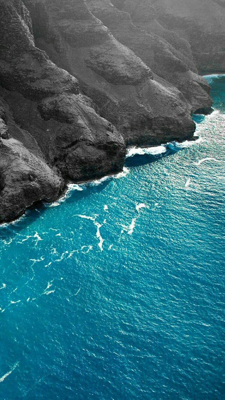 750x1334 Sea breaking on a steep Basalt slope hardened lava