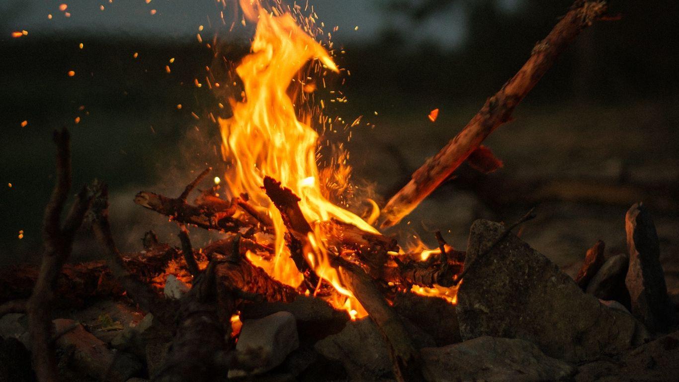 1366x768 Download wallpaper 1366x768 bonfire, fire, sticks, stones