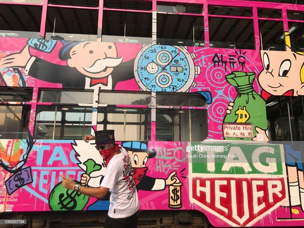 1024x768 Graffiti artist Alec Monopoly in front of the tram he