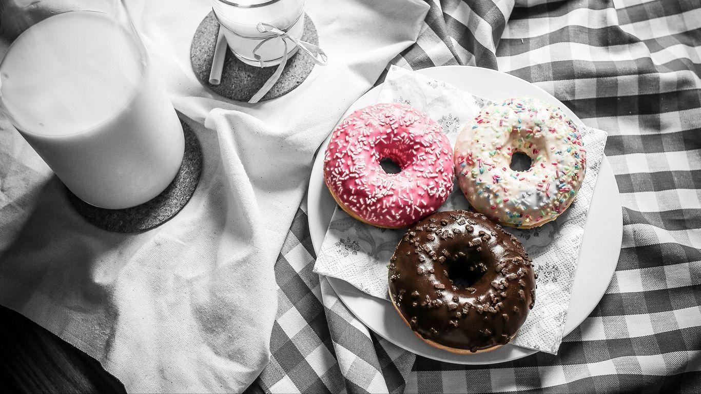 1366x768 Download wallpaper 1366x768 donuts, milk, icing, tablecloth