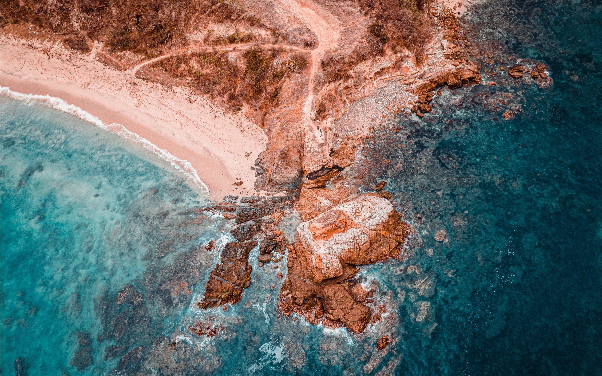 2560x1600 aerial photography of brown rock formation beside Mac