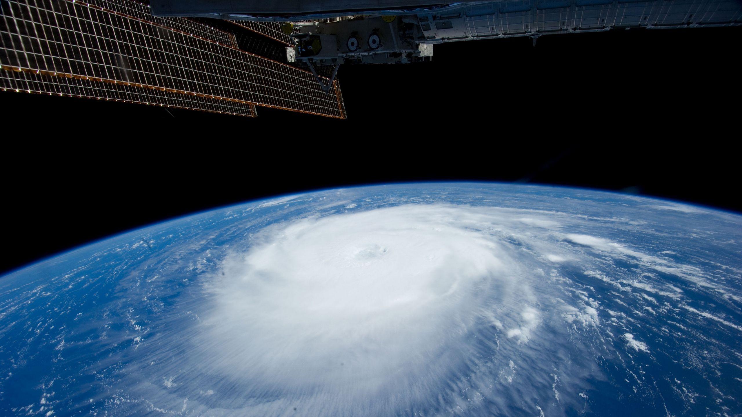 2560x1440 Download wallpaper 2560x1440 hurricane, iss, earth, clouds