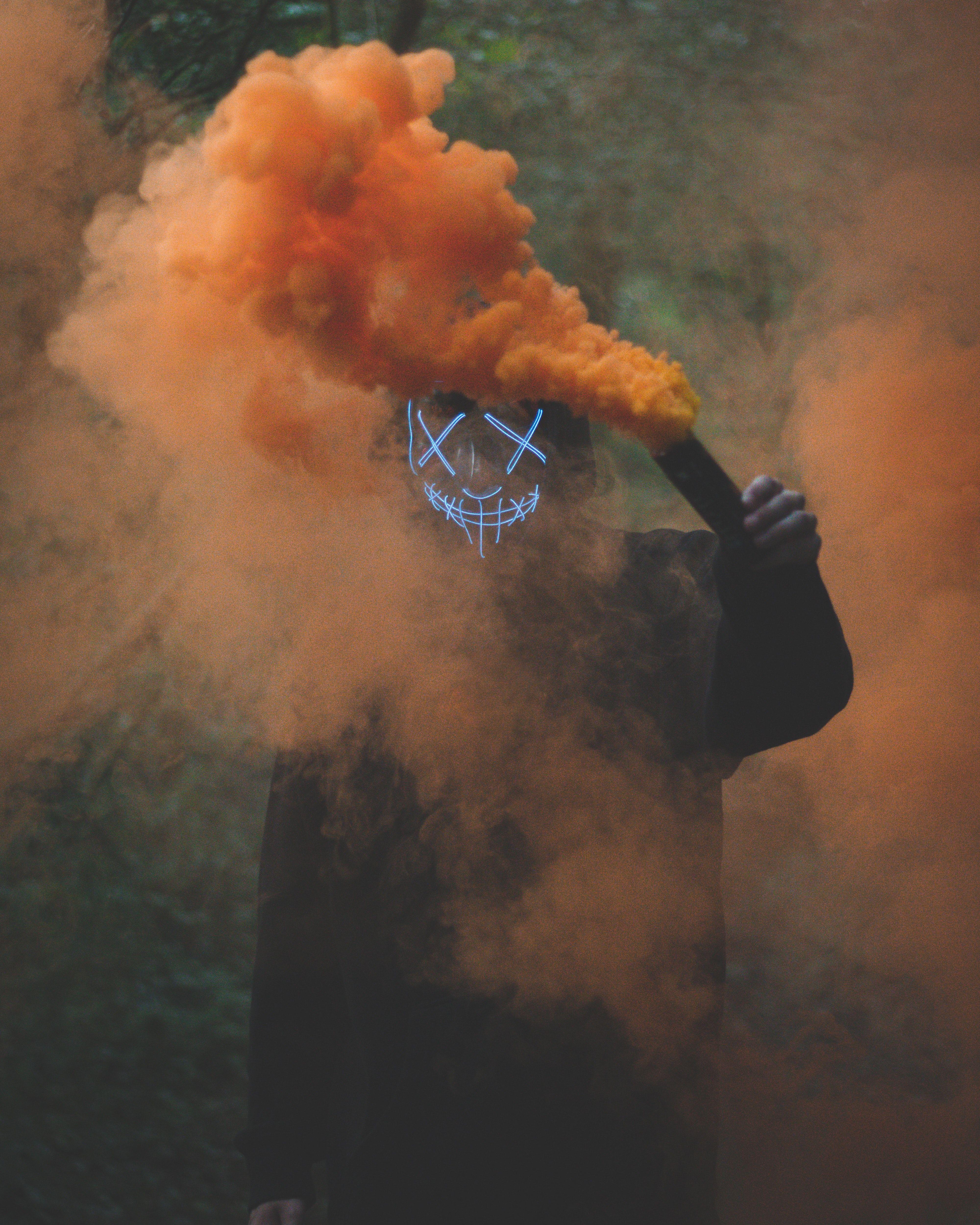 4000x5000 Person Wearing Mask Holding Colored Smoke Bomb · Free Stock