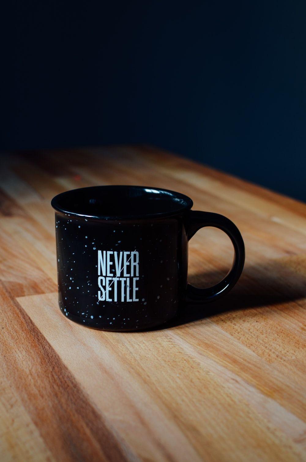 1000x1510 black ceramic mug on table photo