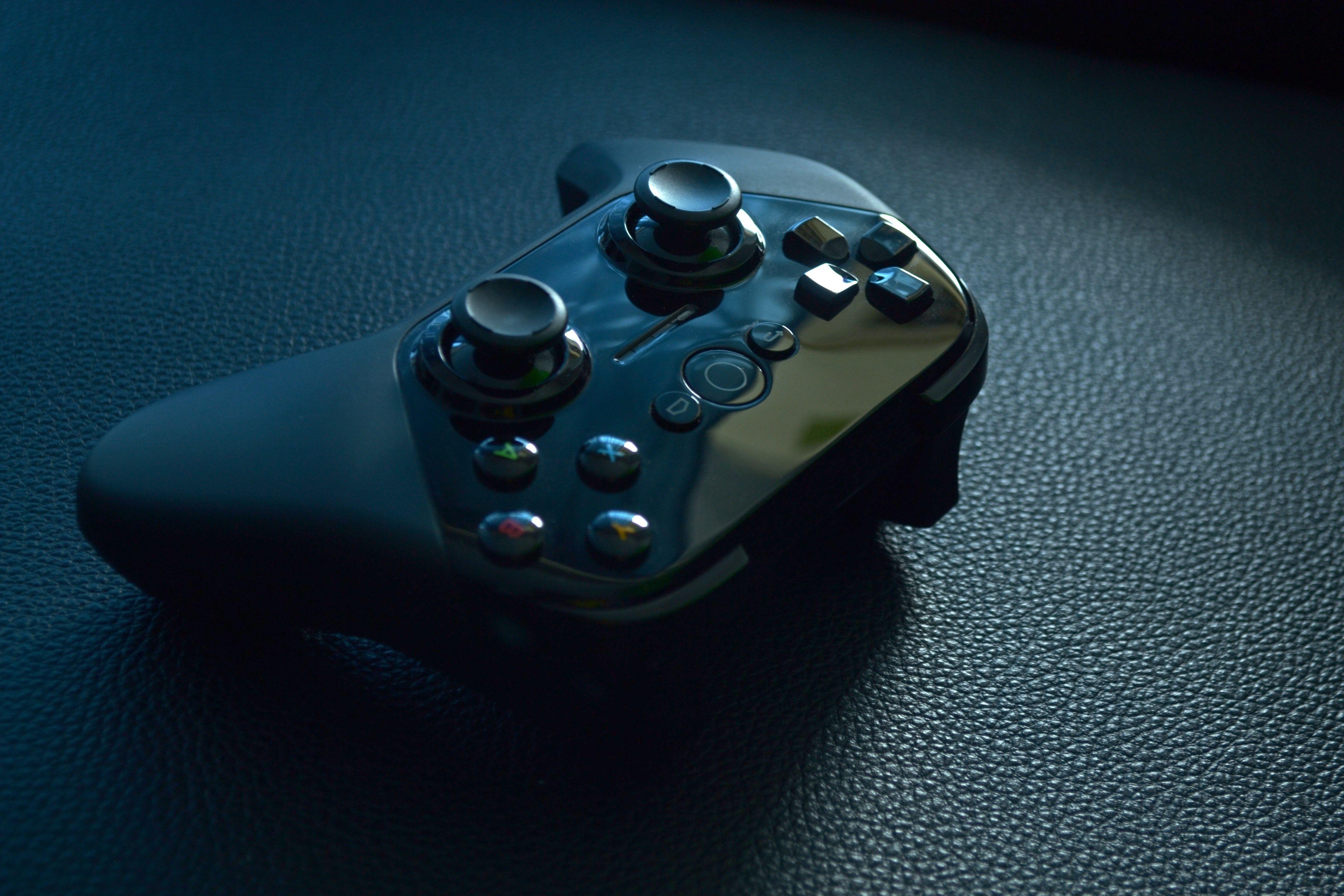 4608x3072 Black Wireless Game Controller on Black Leather · Free Stock