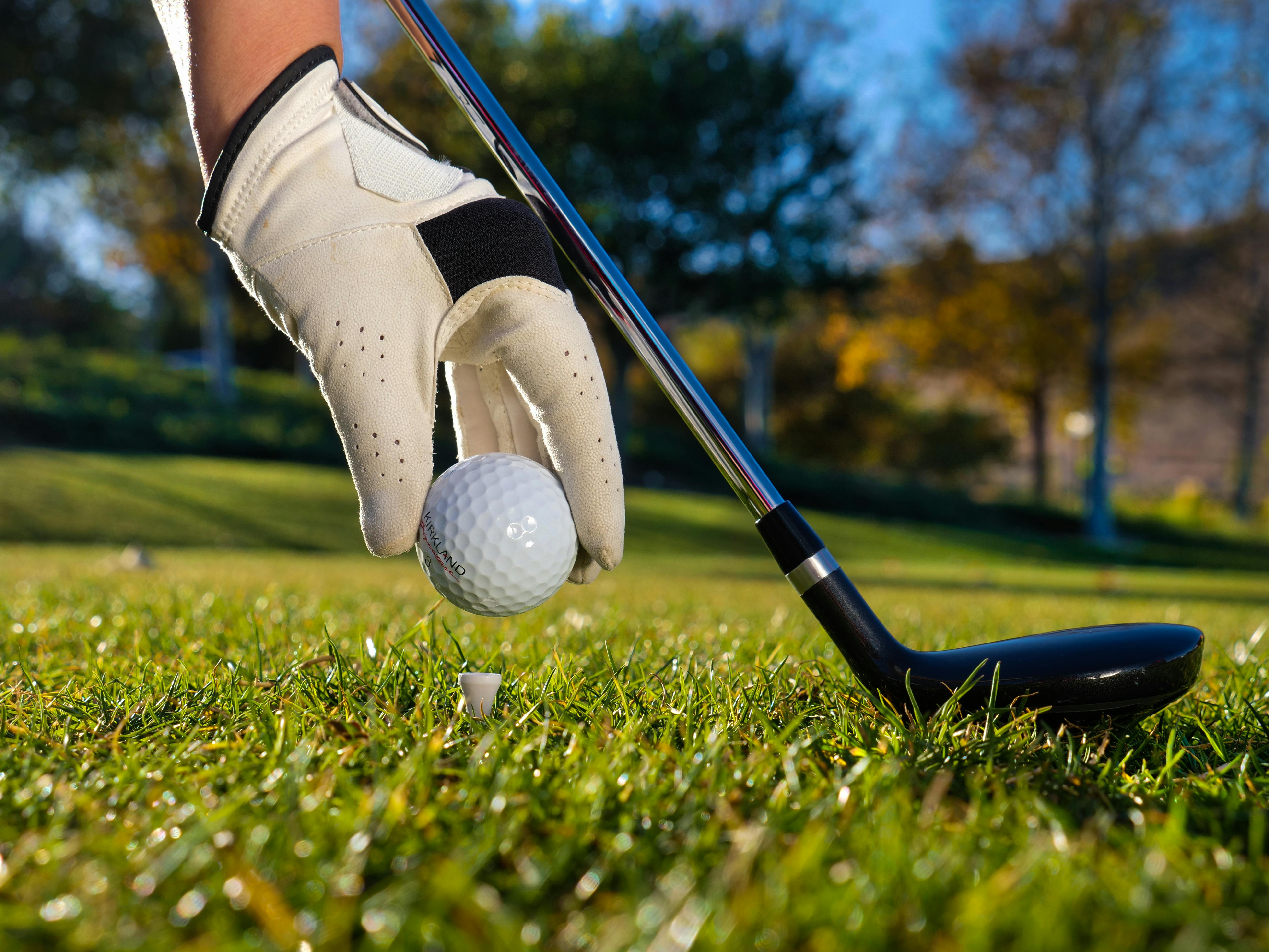 5184x3888 Person Putting Golf Ball on a Tee