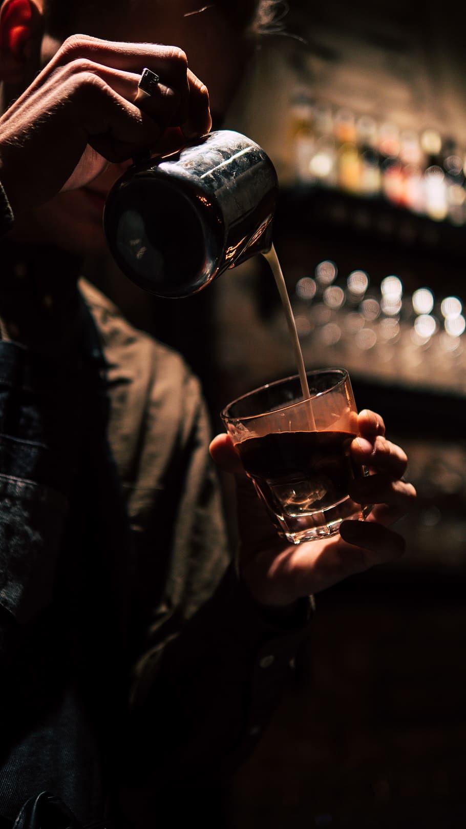 910x1616 man pouring content on drinking glass