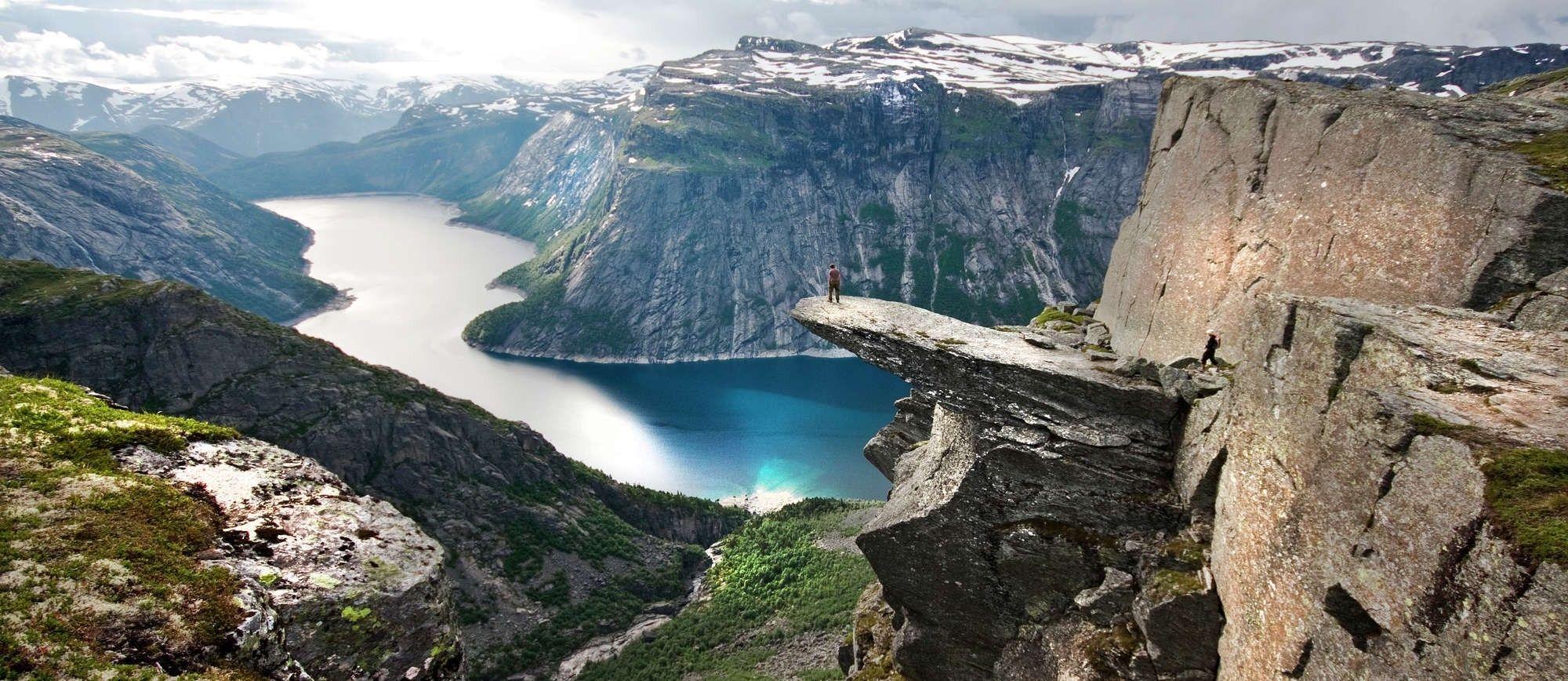 2000x868 sea cliff canyon snow clouds rock norway landscape nature water