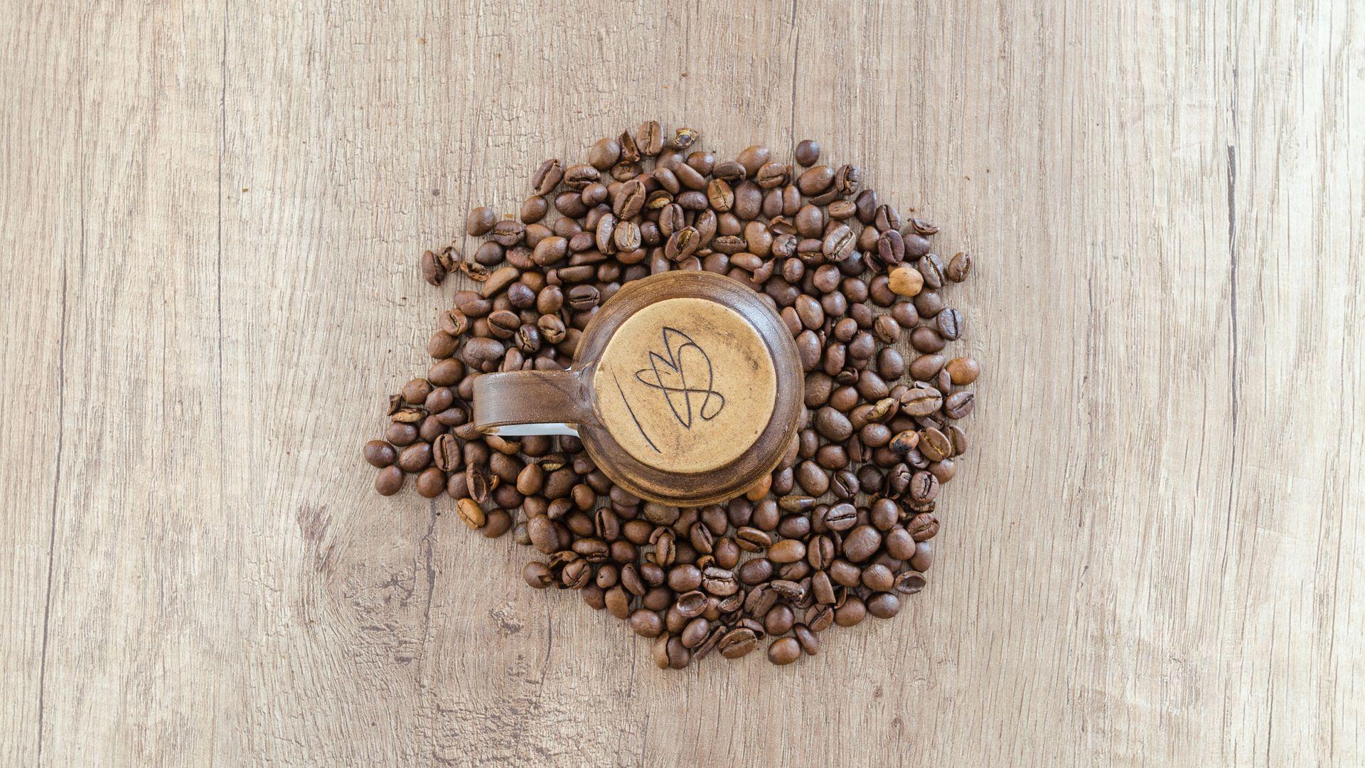1920x1080 Flat Lay Photo of Mug Surrounded by Coffee Beans Wallpaper