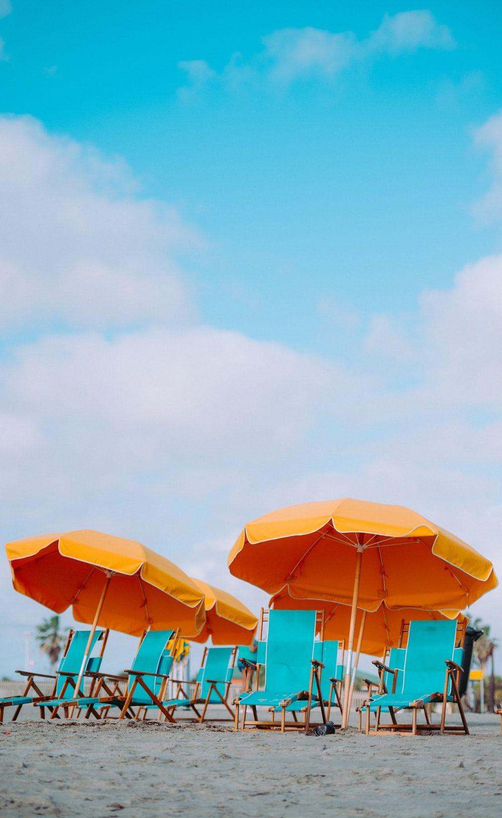 1000x1628 closeup photo of lounger chairs and beach umbrellas photo