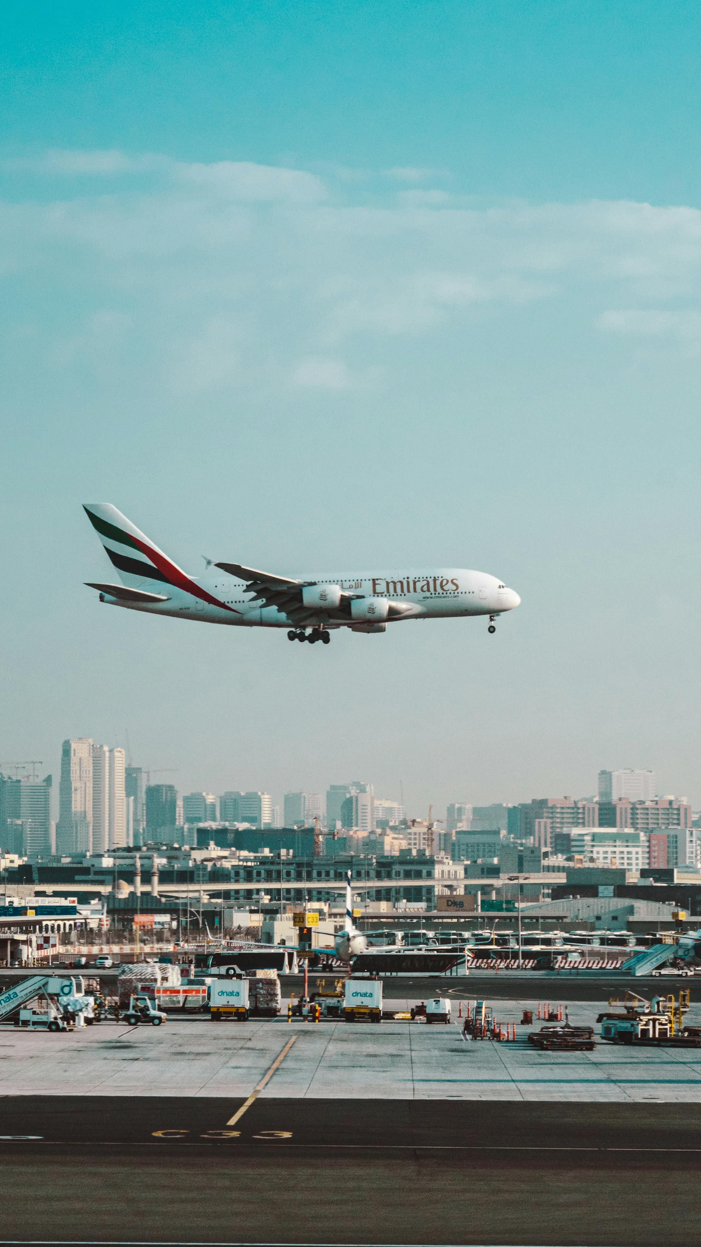 2232x3968 White and Red Passenger Plane Flying