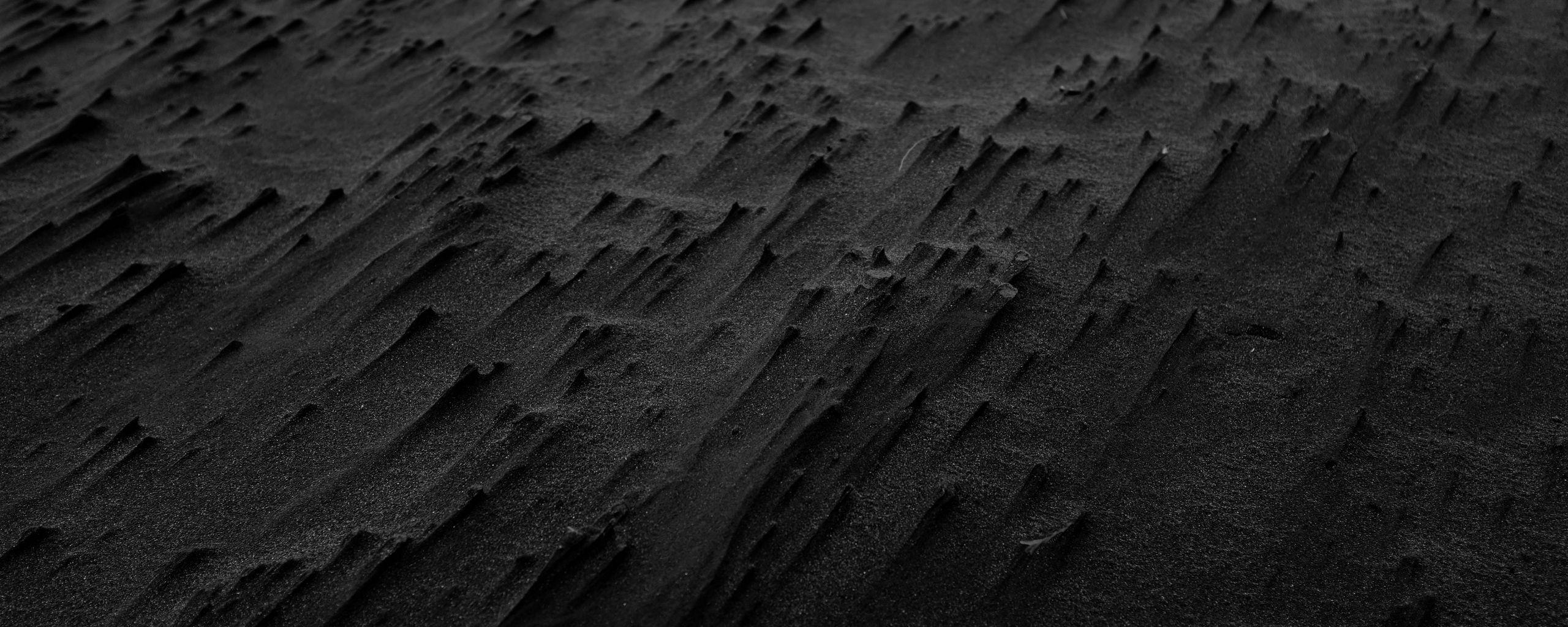 2560x1024 Download wallpaper 2560x1024 sand, black, beach, texture