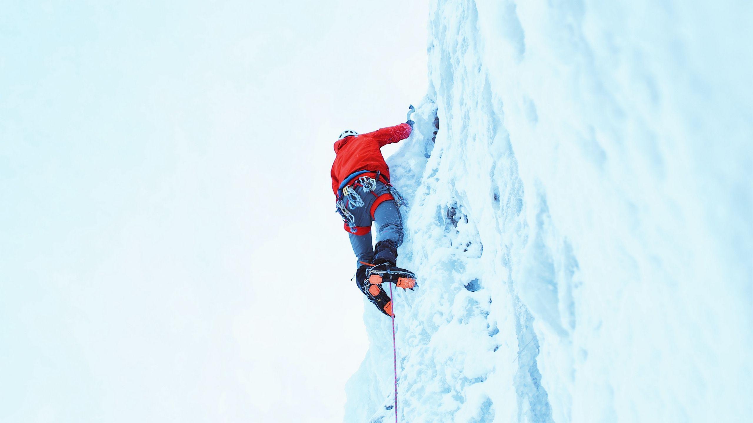 2560x1440 Download wallpaper 2560x1440 climber, snow, mountain