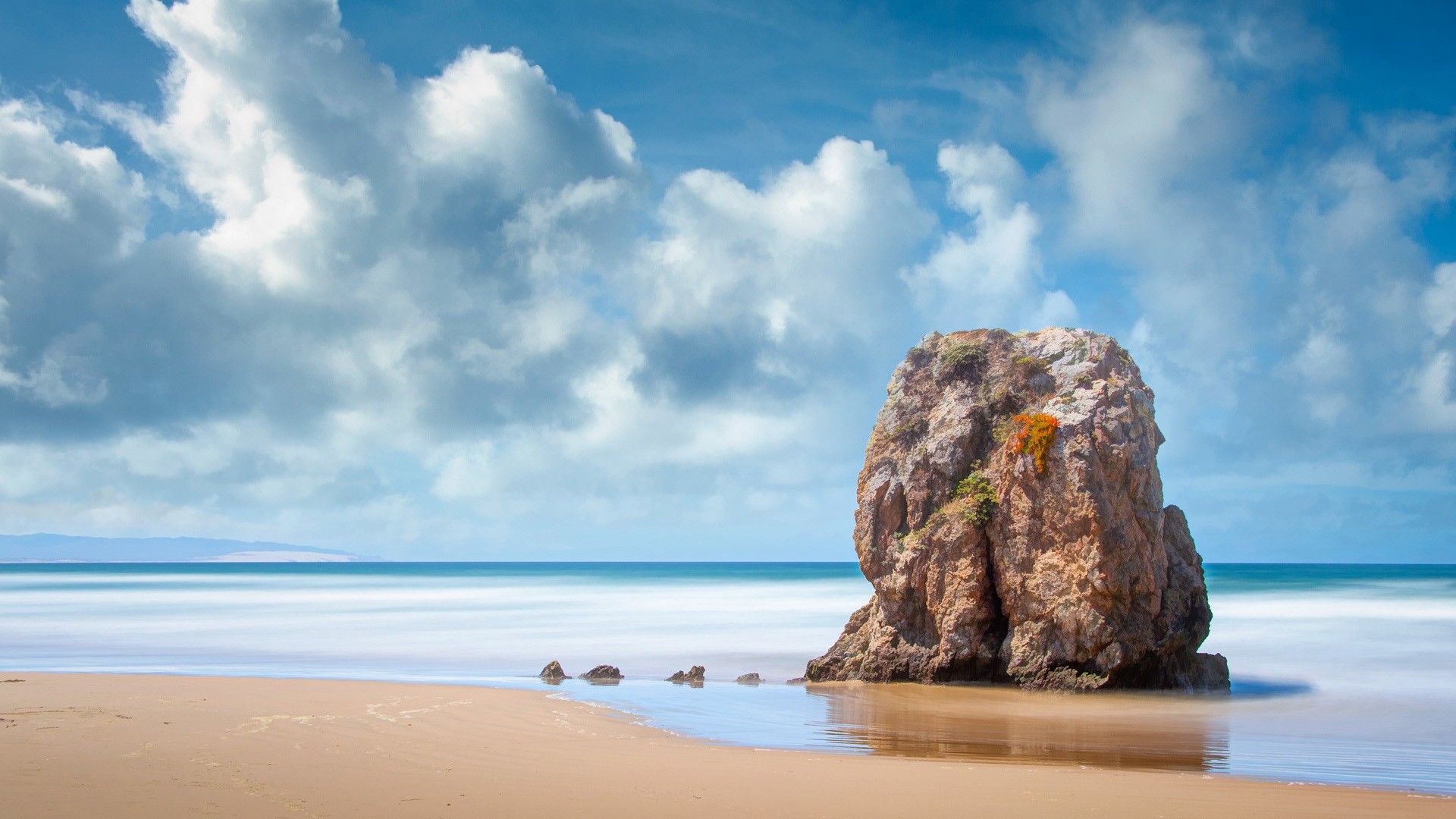 1920x1080 Big Rock Stone On Beach Sand Ocean Waves Under Blue Clouds Sky HD Nature Wallpaper