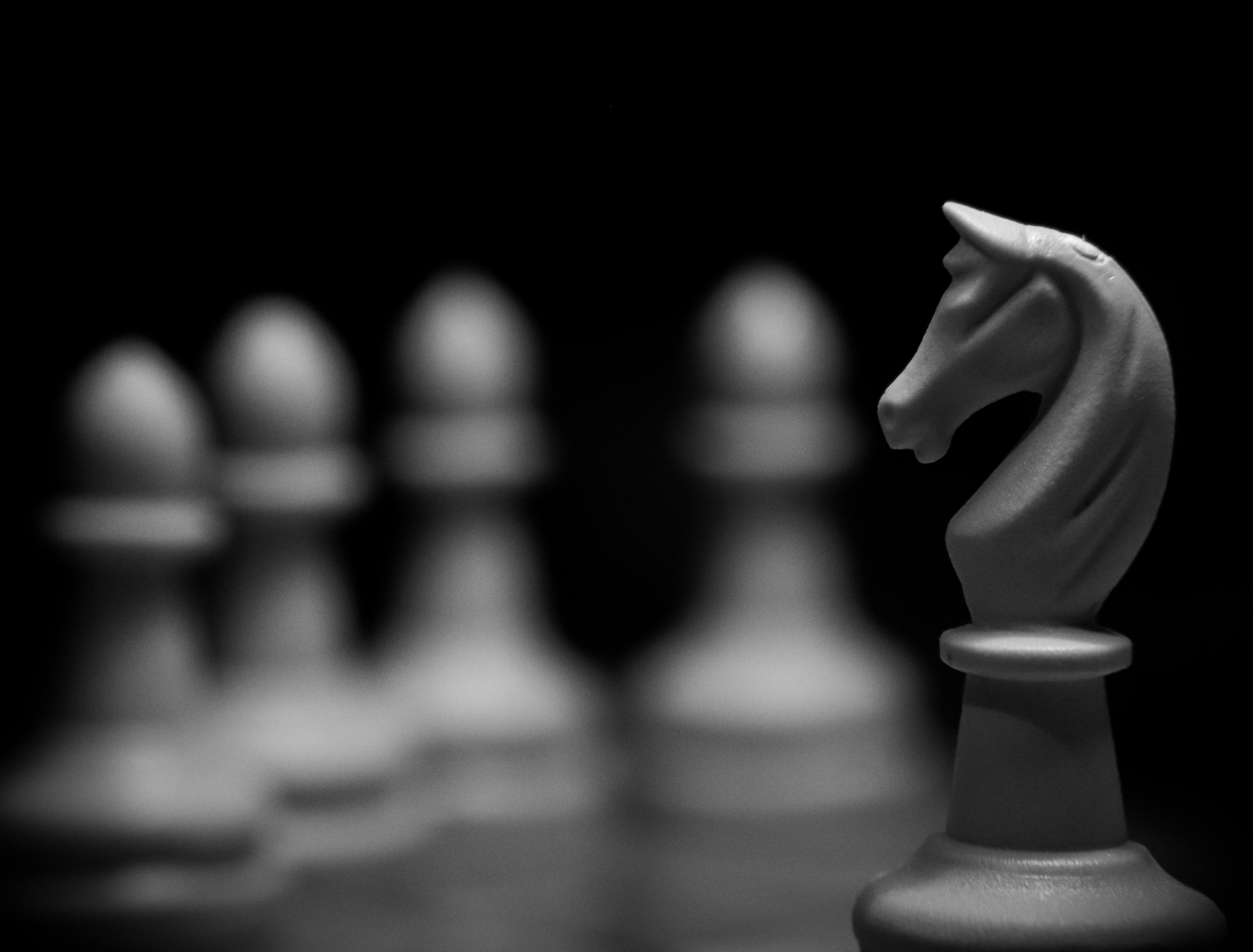 5261x4000 White Knight on Chess Board against Blurry Pieces · Free