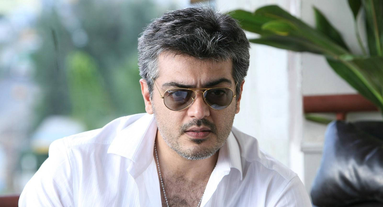 1600x866 Captivating Stare: Ajith Kumar In A White Polo HD Photo Wallpaper