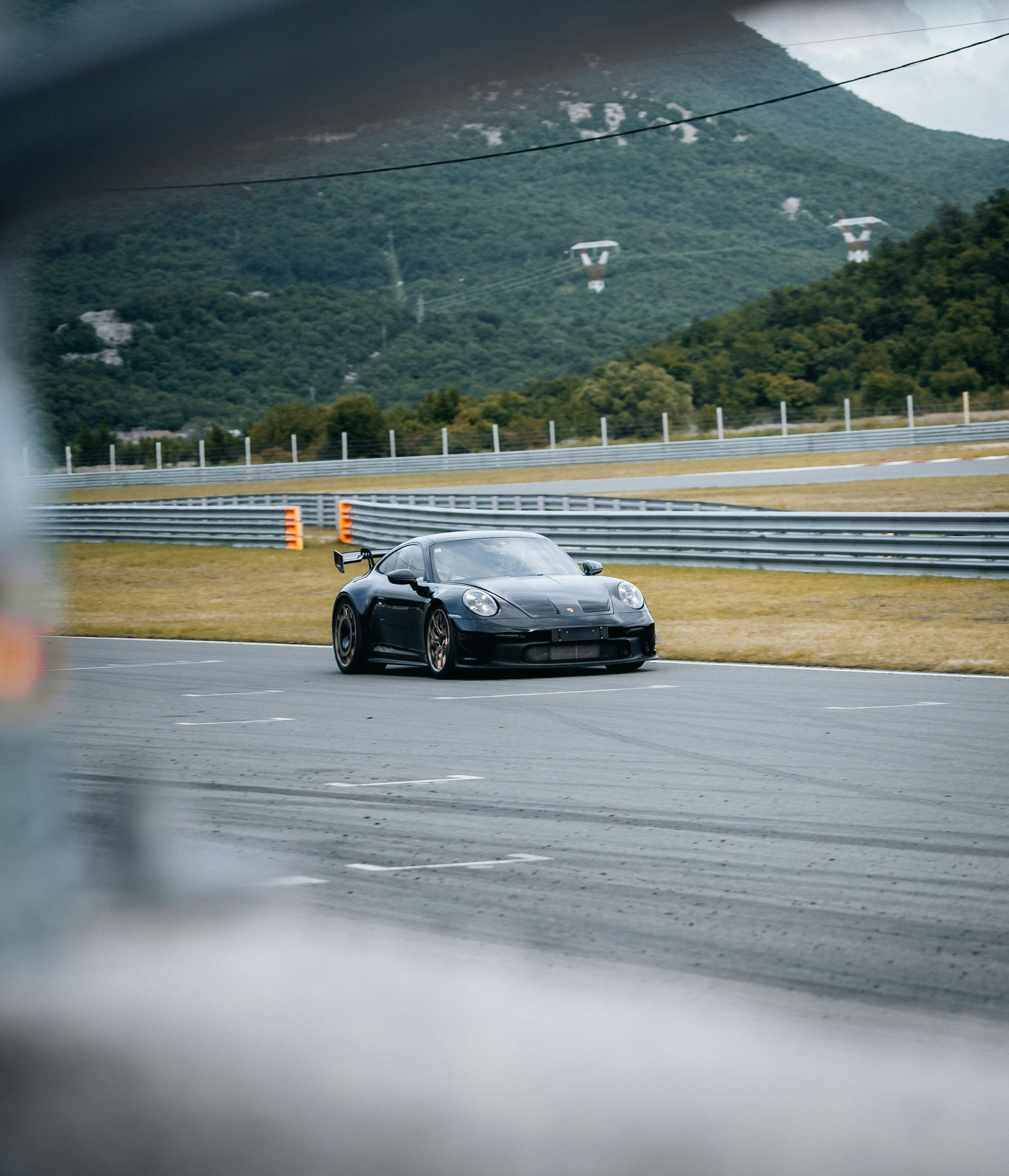 3000x3496 A black sports car driving down a race track photo