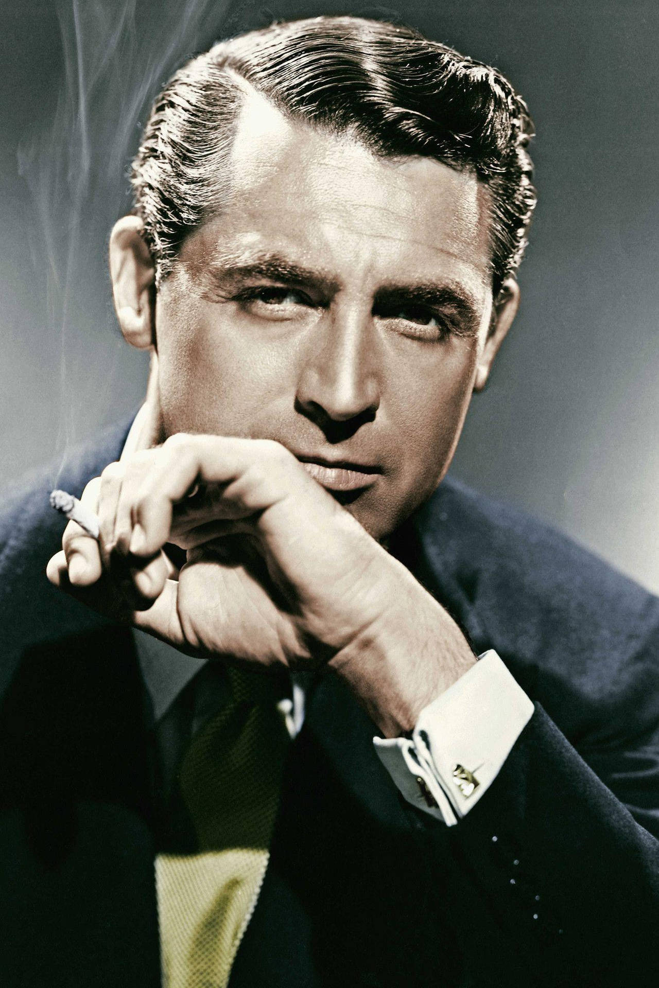 1280x1920 Download Classic Hollywood Star, Cary Grant, Captured in a Relaxed Moment Wallpaper