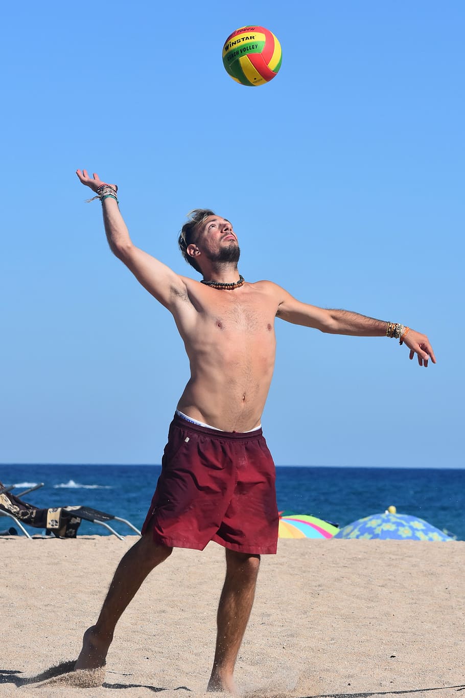 910x1365 HD wallpaper: man playing volleyball at the beach, sports, people
