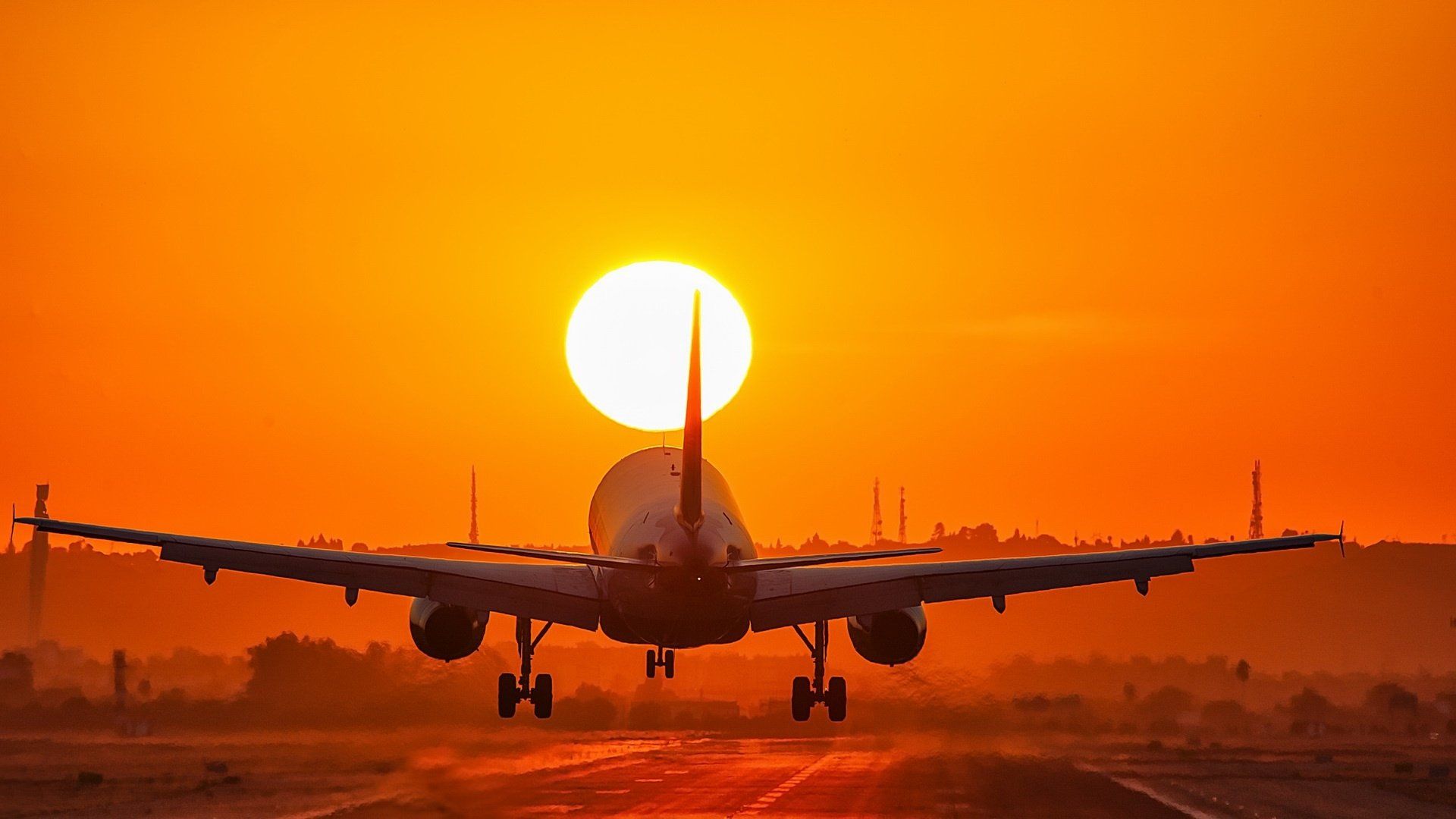1920x1080 Stunning Sunset: HD Wallpaper of a Plane against an Orange Skyx1080