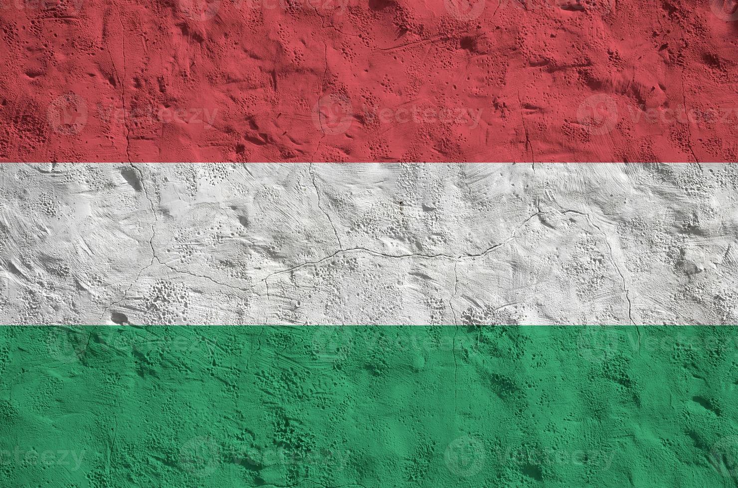 1480x980 Hungary flag depicted in bright paint colors on old relief plastering wall. Textured banner on rough background