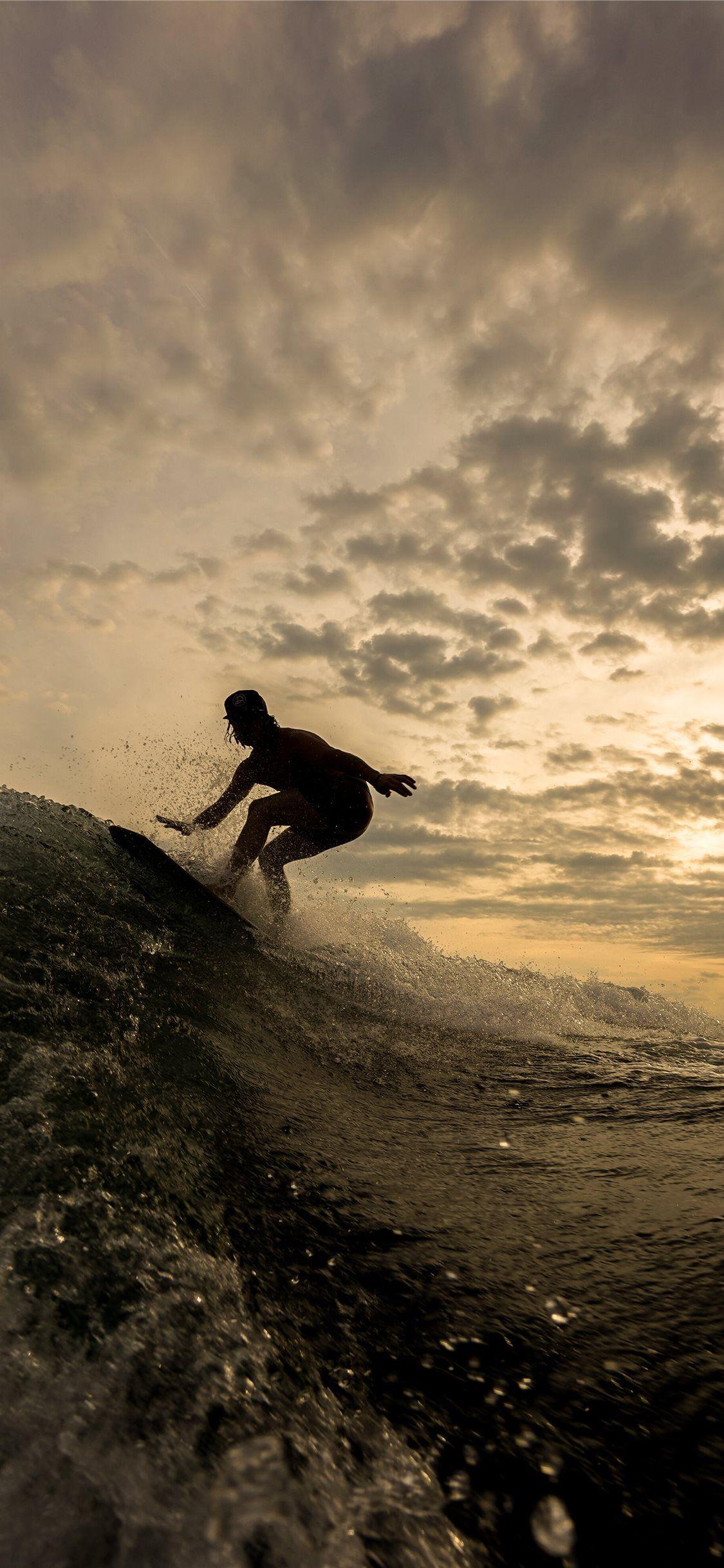 1125x2436 silhouette of person riding on surfboard iPhone 11 Wallpaper Free