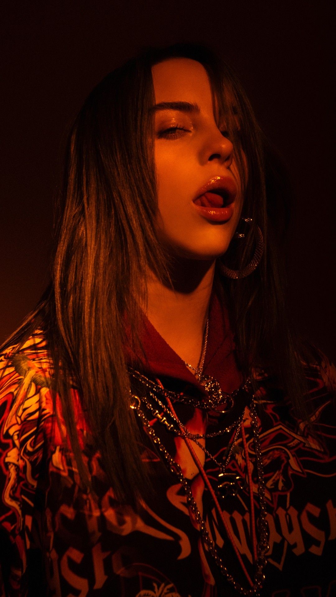 1080x1920 Billie Eilish Is Standing In Dark Background With Shadow Wearing Colorful Coat 4K 5K HD Celebrities Wallpaper