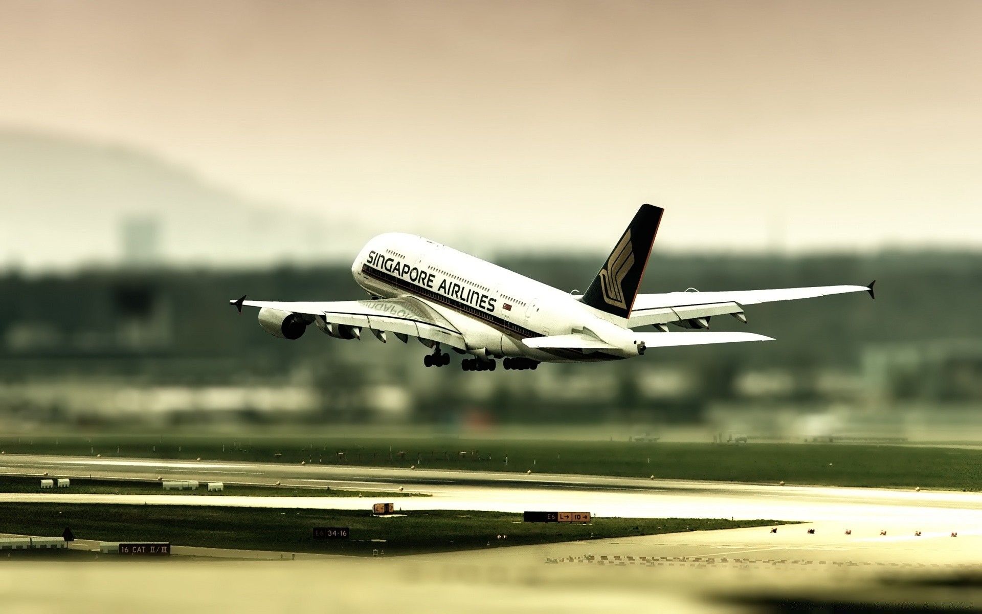 1920x1200 A plane taking off from the airport on a blurry background for your phone