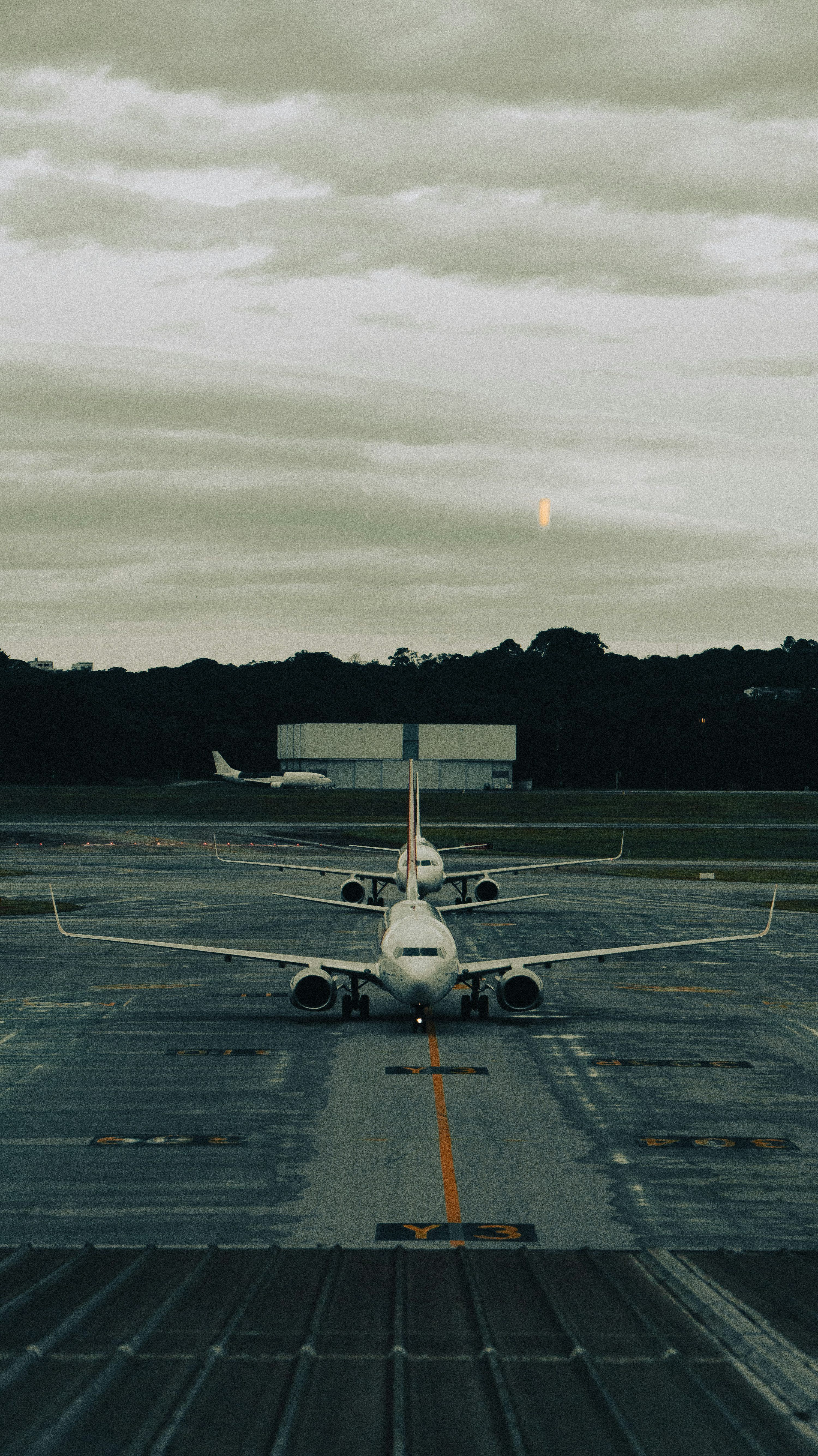 3000x5338 Airplanes lined up on the runway, ready for takeoff. photo