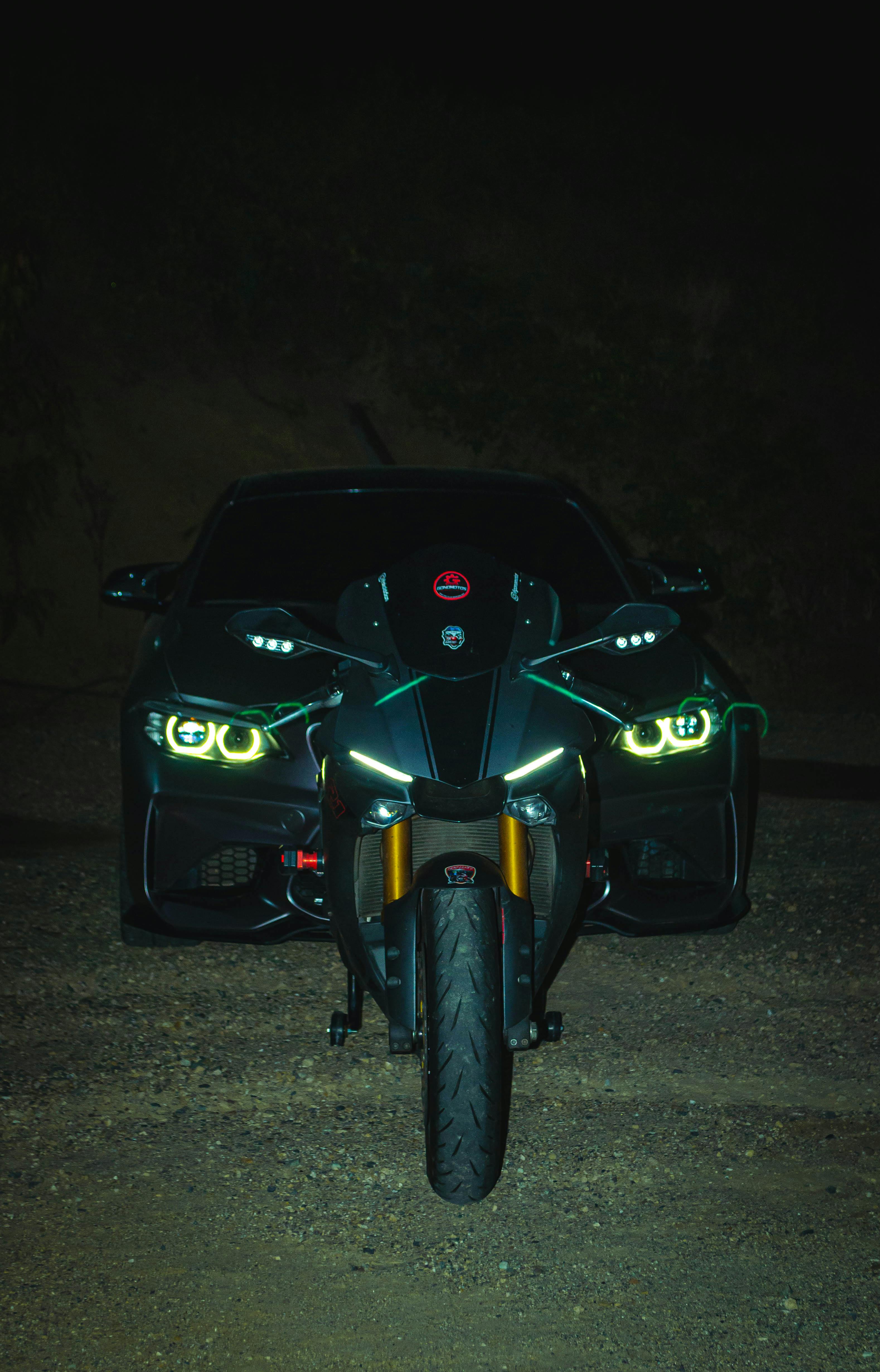 3157x4920 Motorcycle in Front of a Luxurious BMW Car at Night · Free