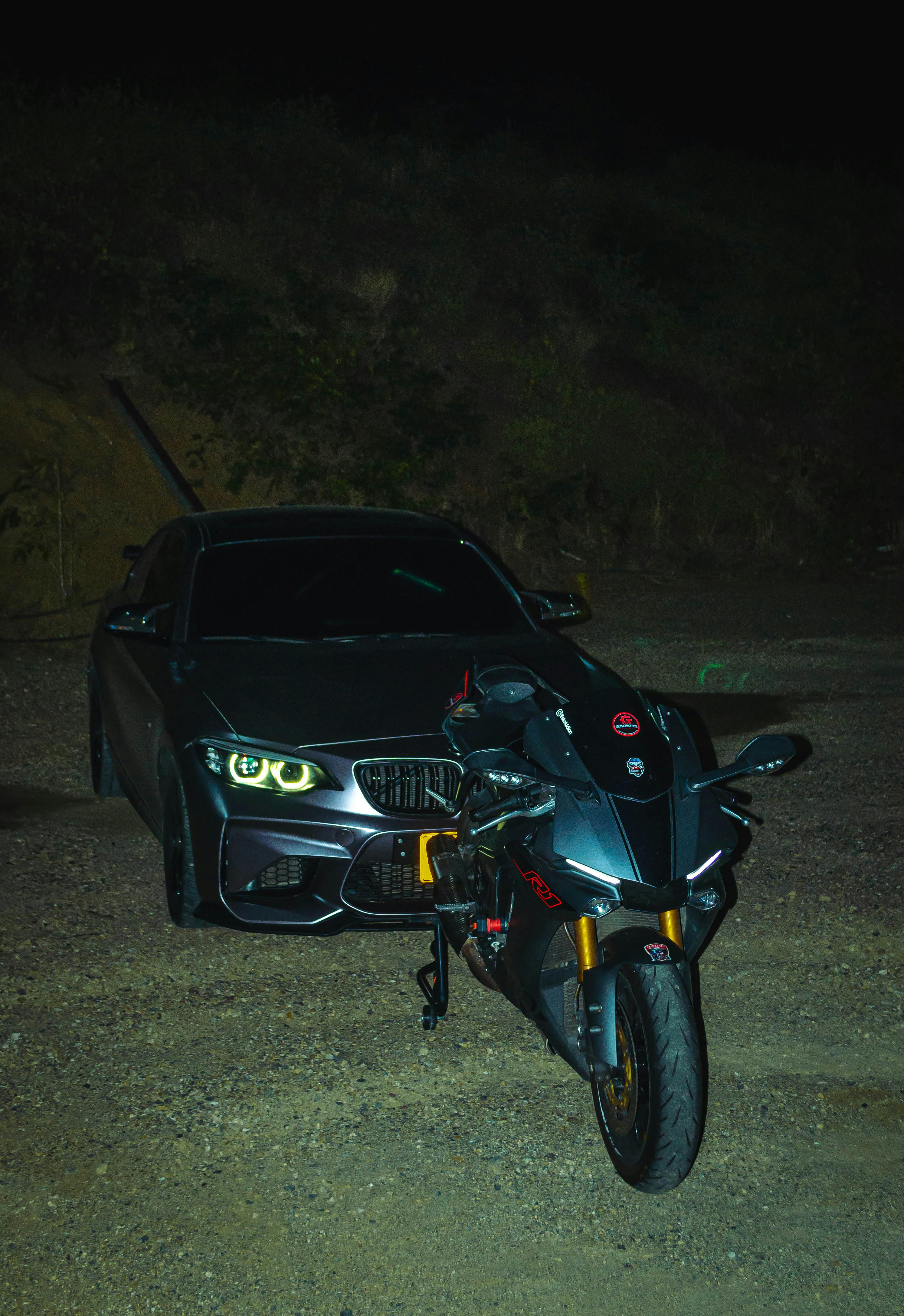 2988x4348 Motorcycle in Front of a Luxurious BMW Car at Night · Free