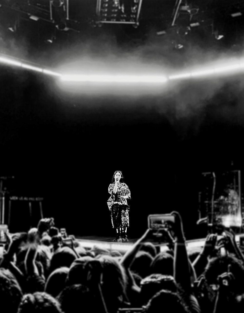 1000x1284 greyscale photography of person performing on stage photo