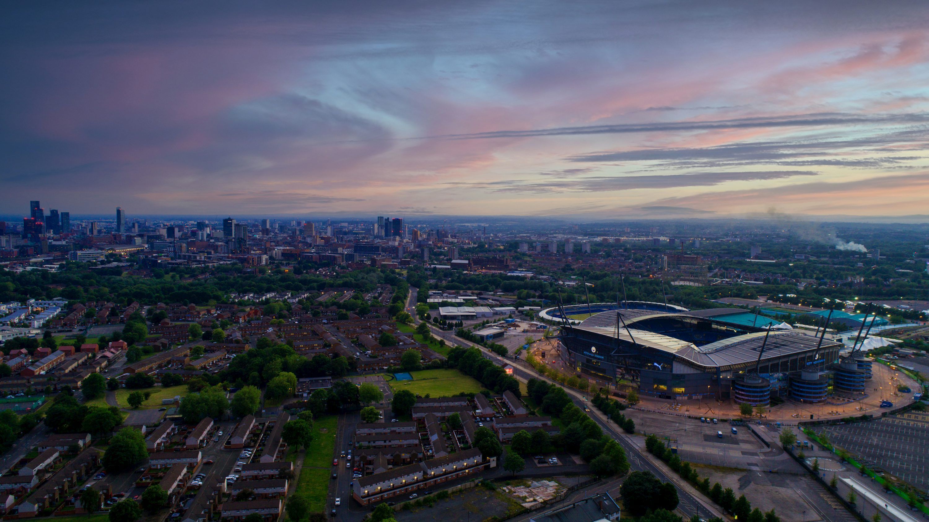 3000x1686 An aerial view of a stadium with a city in the background photo