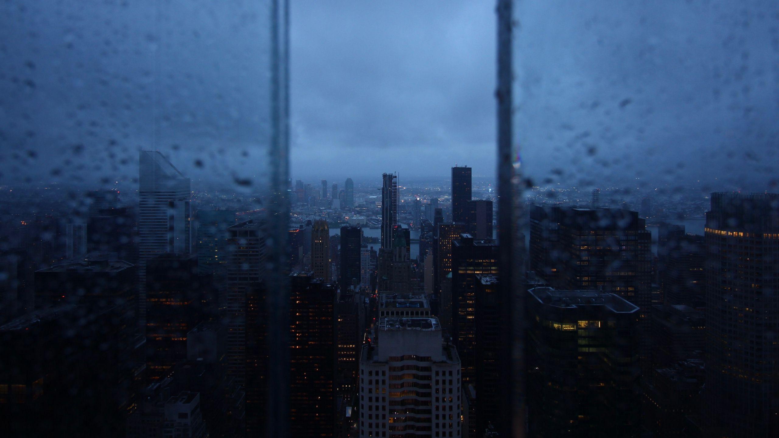 2560x1440 Download wallpaper 2560x1440 night city, window, rain, skyscrapers