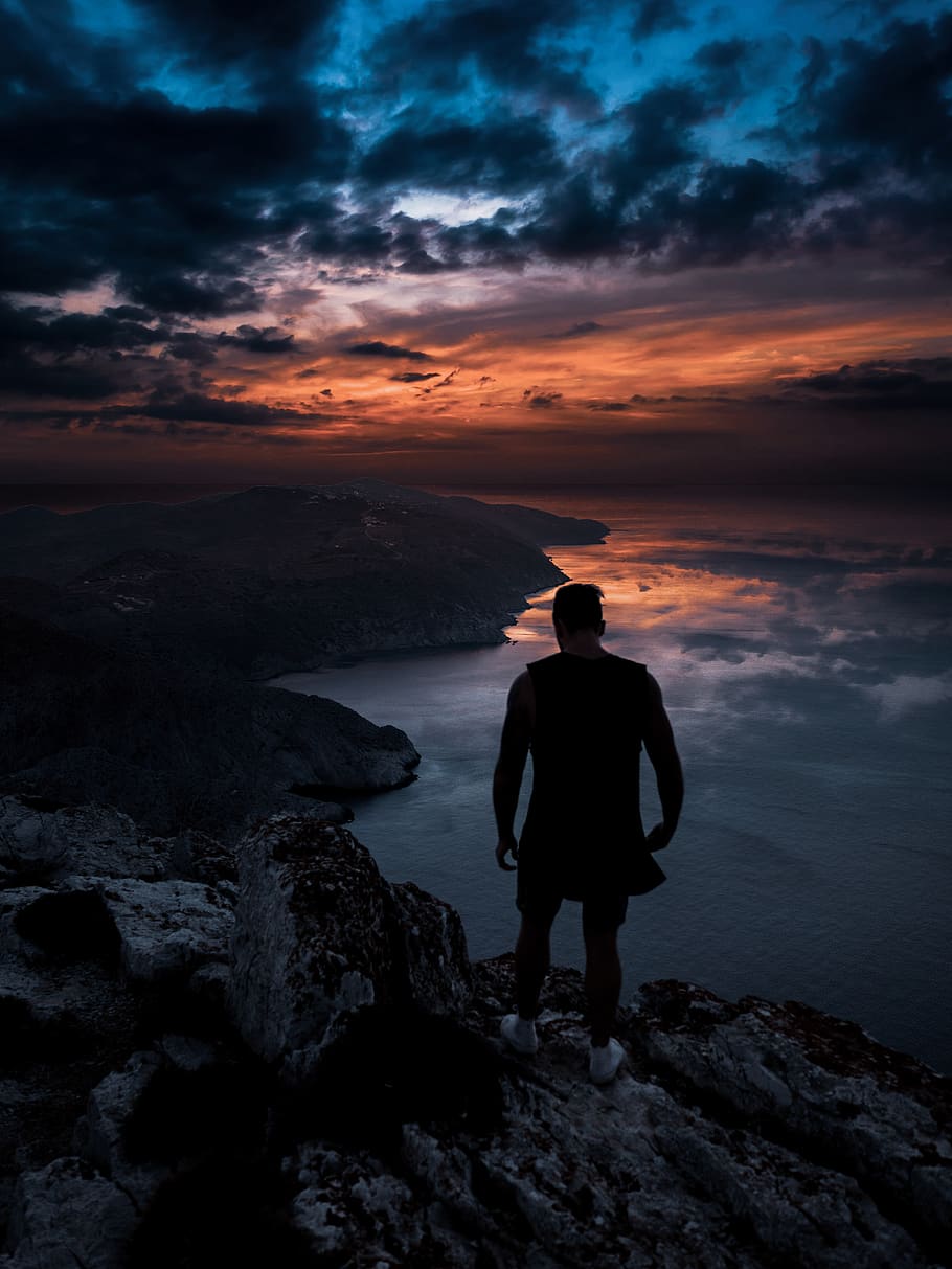 910x1213 HD wallpaper: Photo of Man Standing on Cliff, back view, backlit, bay, beach