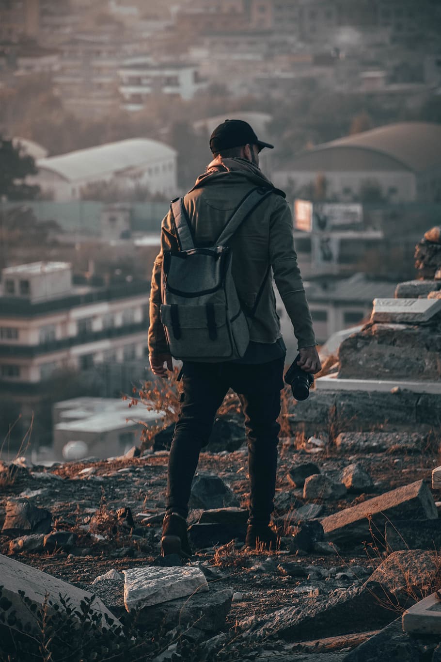 910x1365 HD wallpaper: Photo of Man Holding Camera, back, back view, backpack, blur