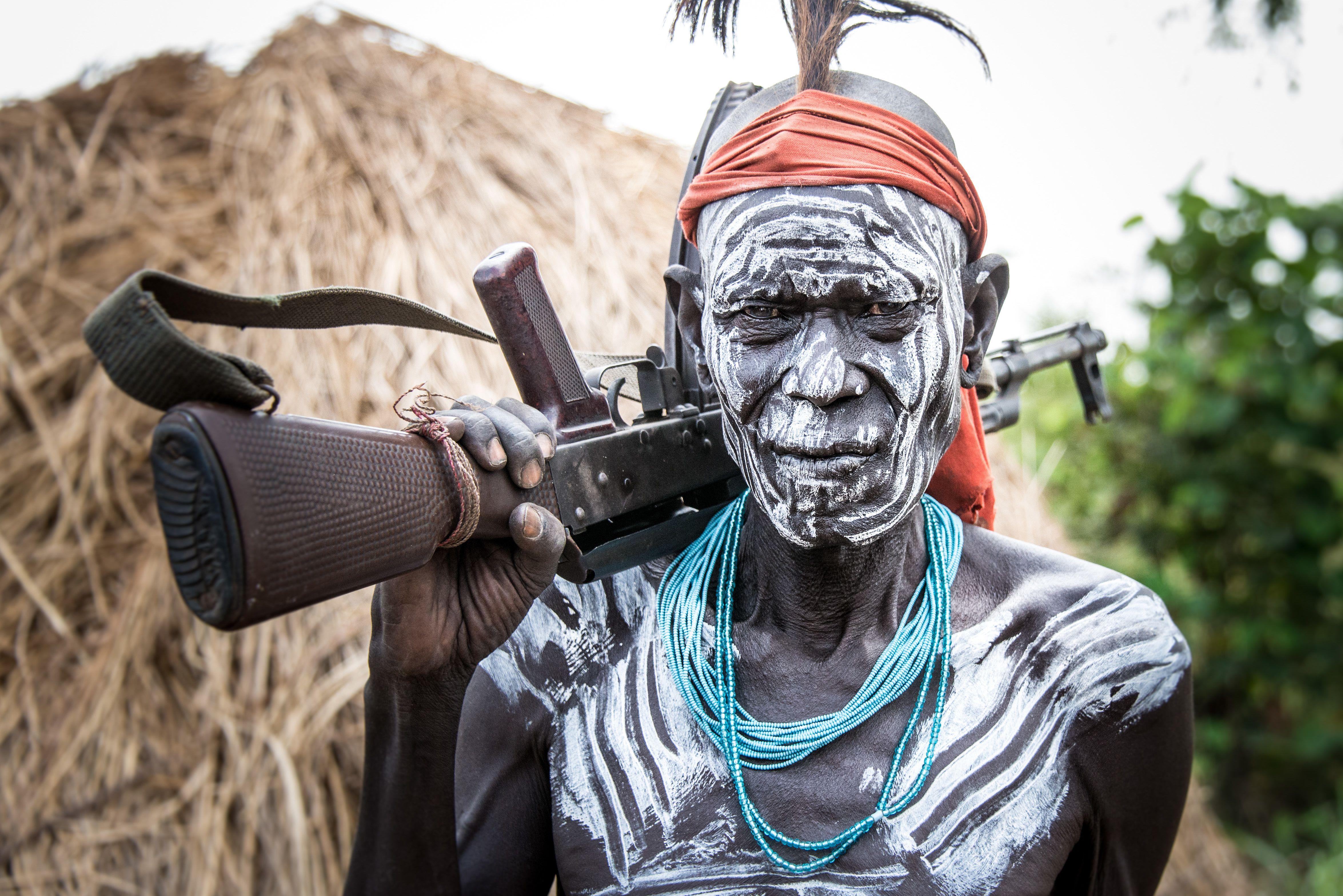 4699x3137 Photo Men Assault rifle Mursi warrior Omo wally Ethiopia 4699x3137